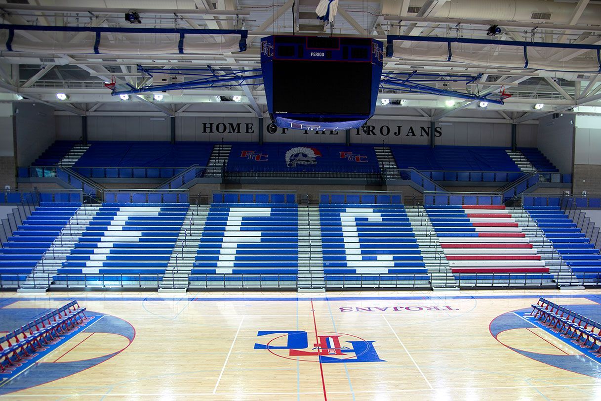 The gymnasium floor at Trojan Arena in CO that features EXCEL Seat Modules in red, white and blue colors for a striking look!
