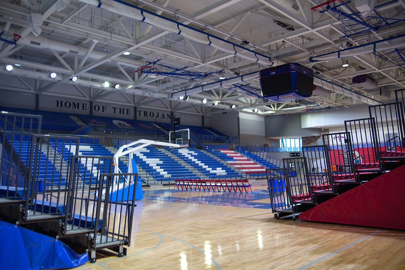 The gymnasium floor at Trojan Arena in CO that features EXCEL Seat Modules in red, white and blue colors for a striking look!