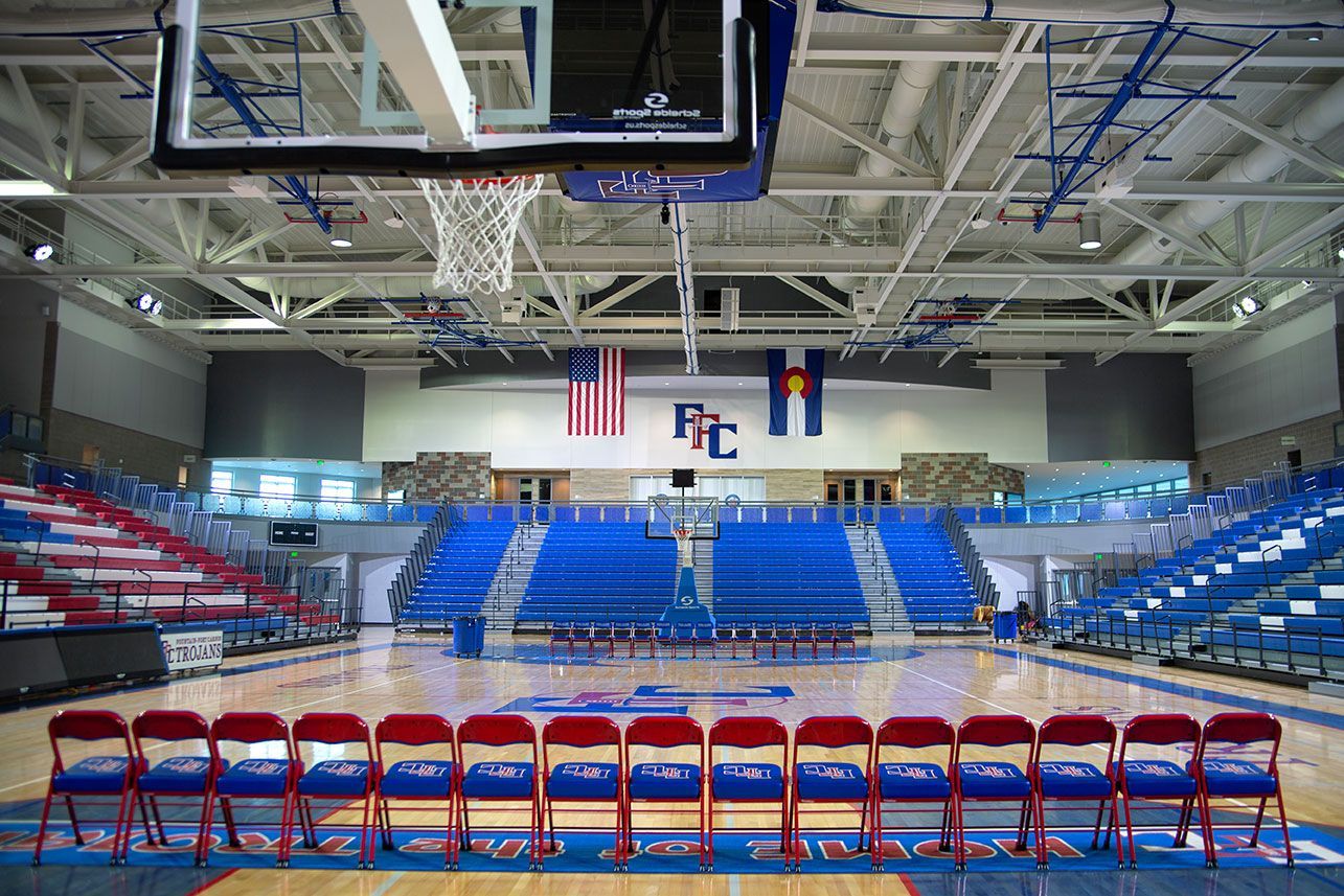 The gymnasium floor at Trojan Arena in CO that features EXCEL Seat Modules in red, white and blue colors for a striking look!