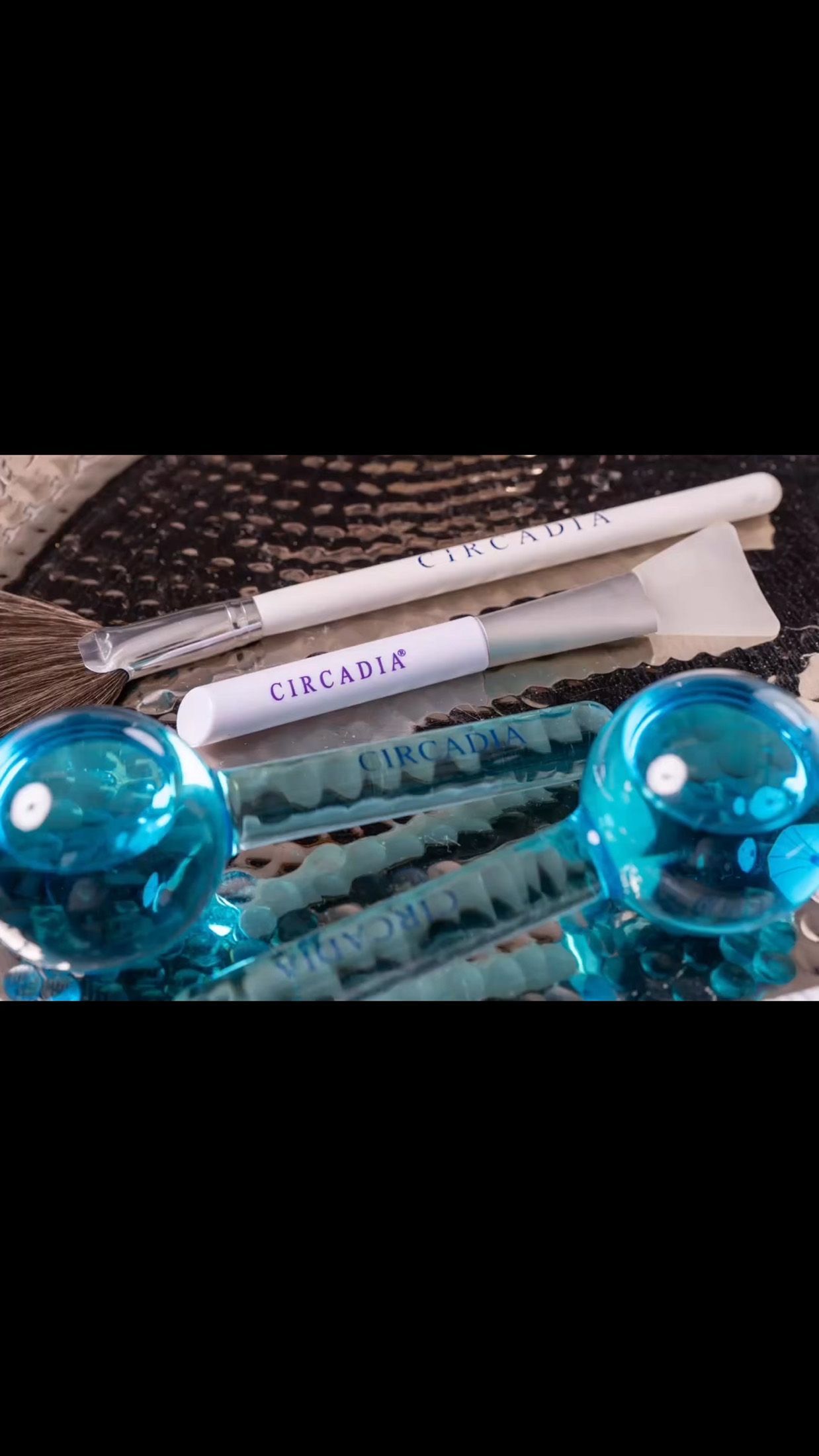 Blue face globes, white cosmetic applicators, and cooling sticks.