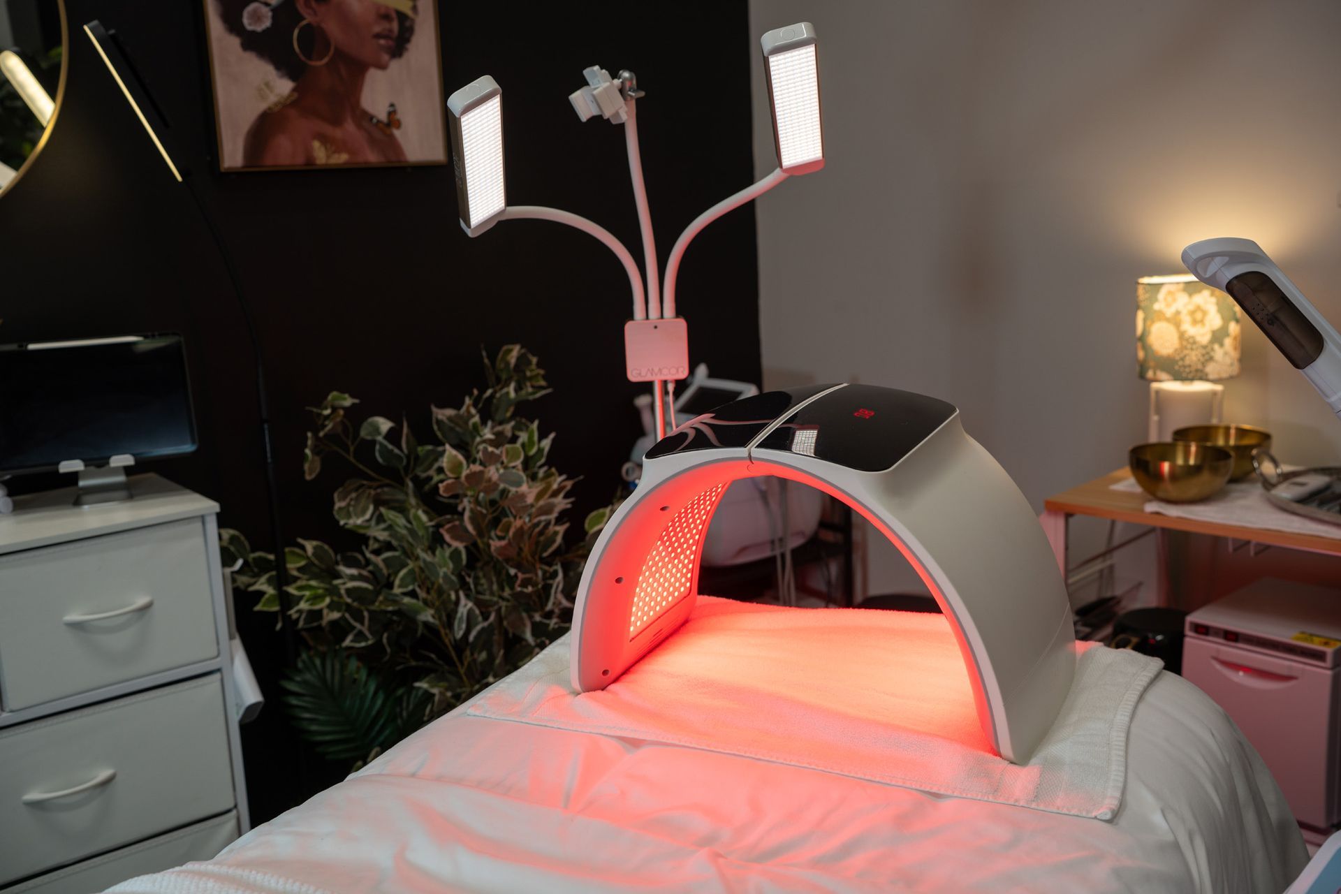 Red light therapy device on a massage table in a spa.