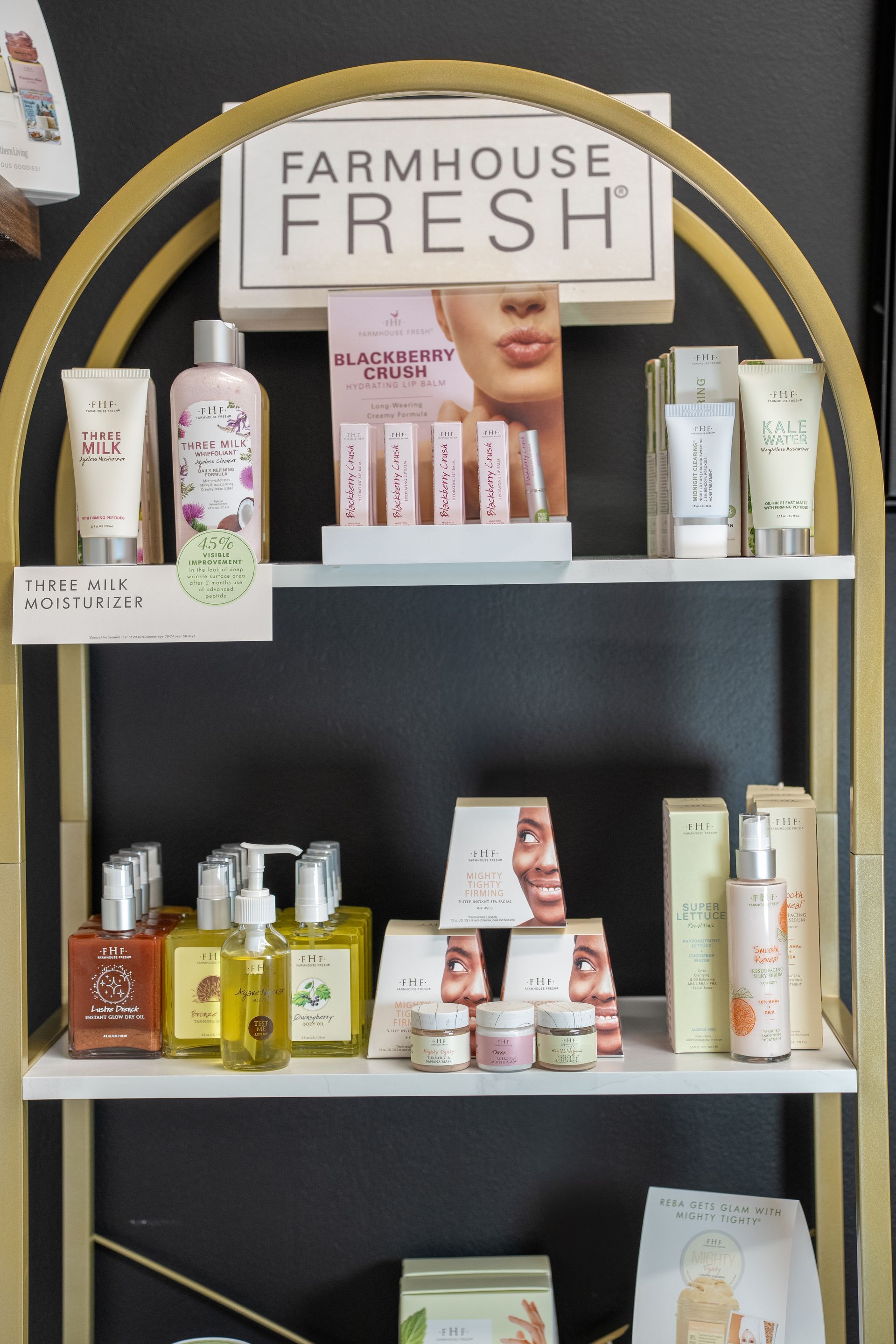 Shelf display of Farmhouse Fresh skincare products with a gold arched frame.
