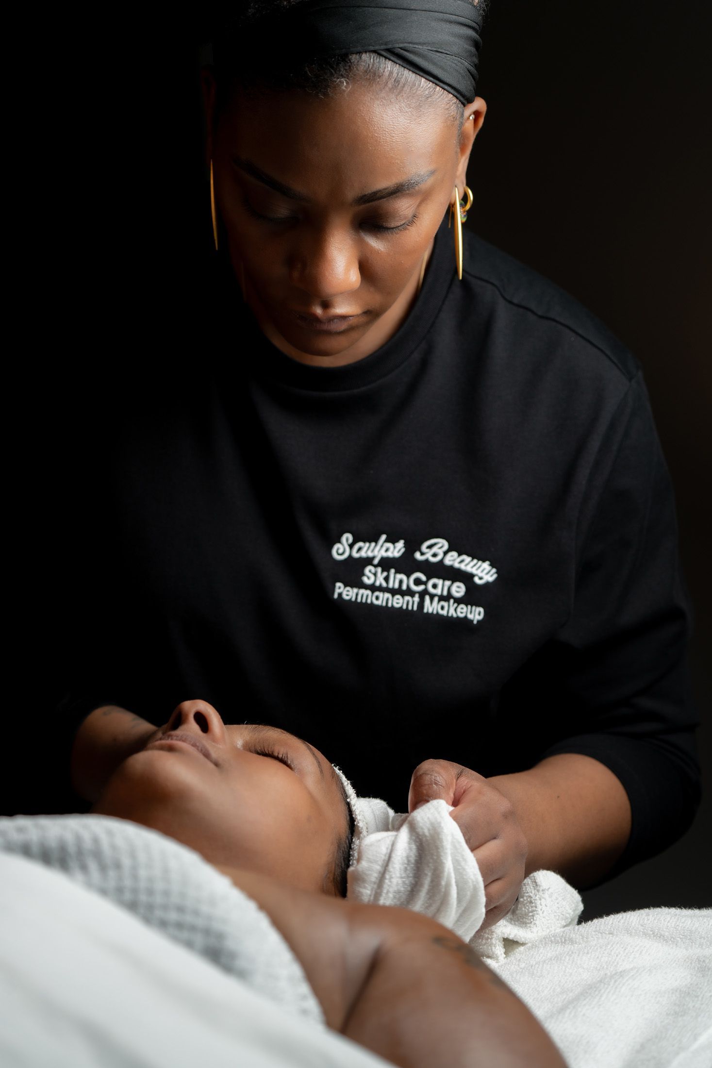 Esthetician performing facial treatment.