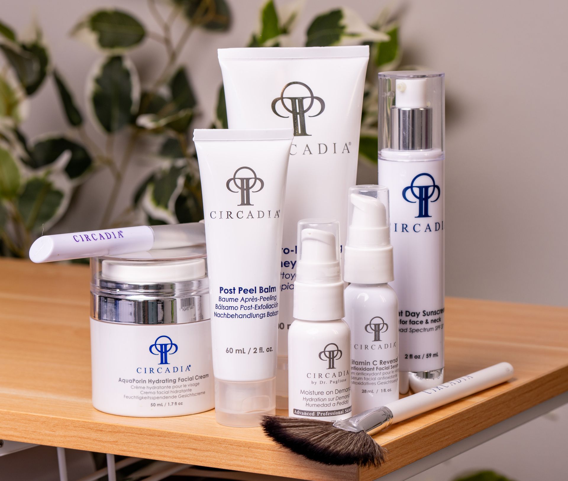 Various skincare products with white and blue labels on a wooden surface.