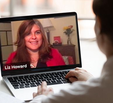 A man is using a laptop with Liz Howard on the screen