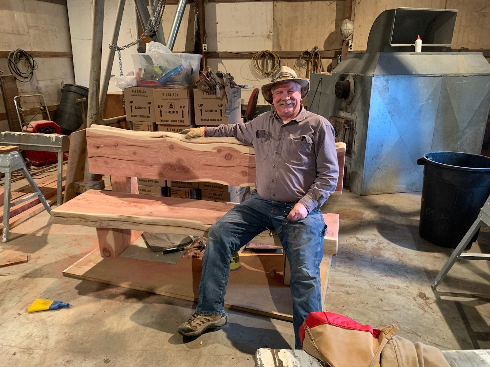 snellen wood products employee sitting on custom cedar bench