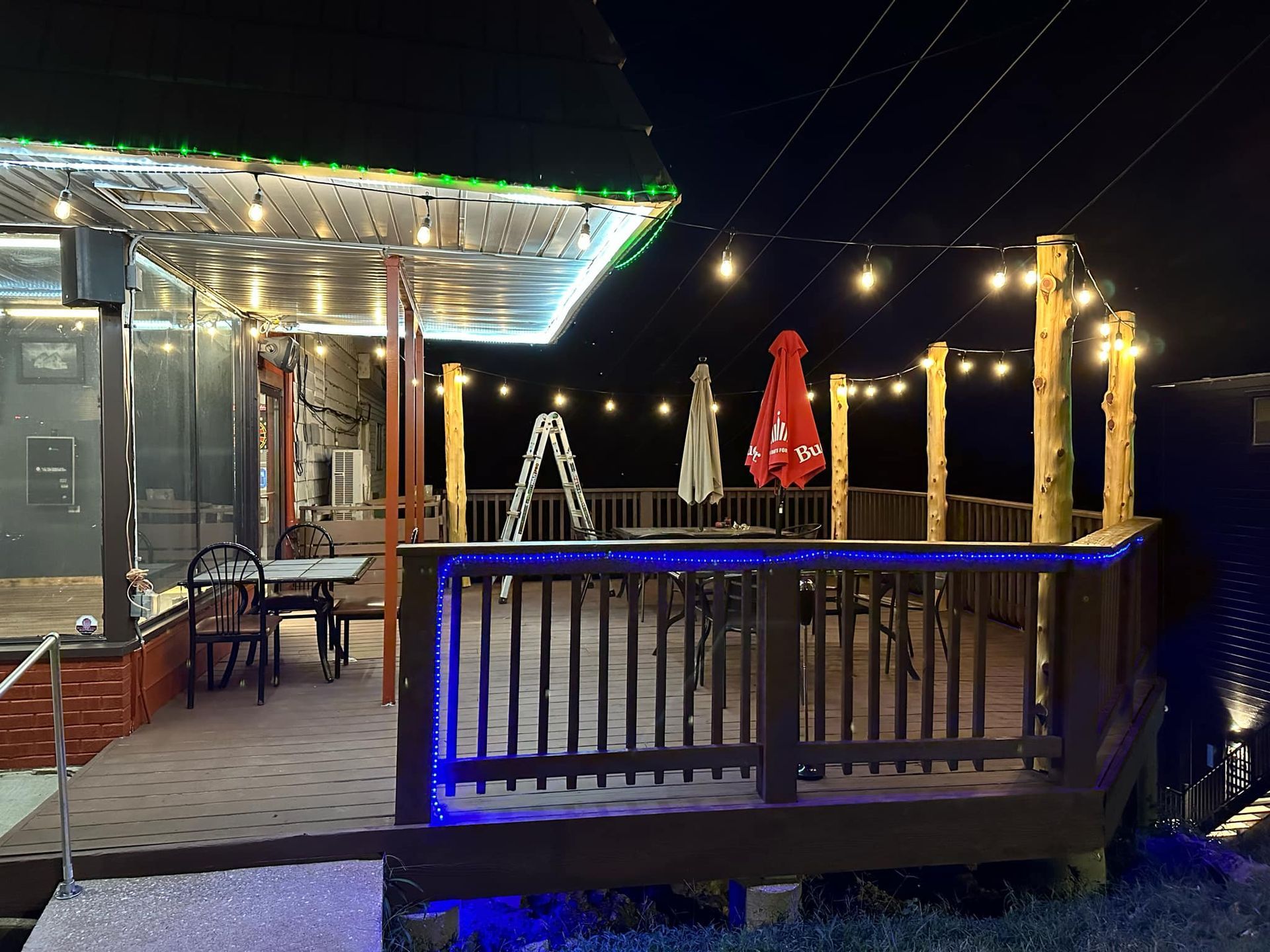 Nighttime shot of back deck with cedar posts and string lights