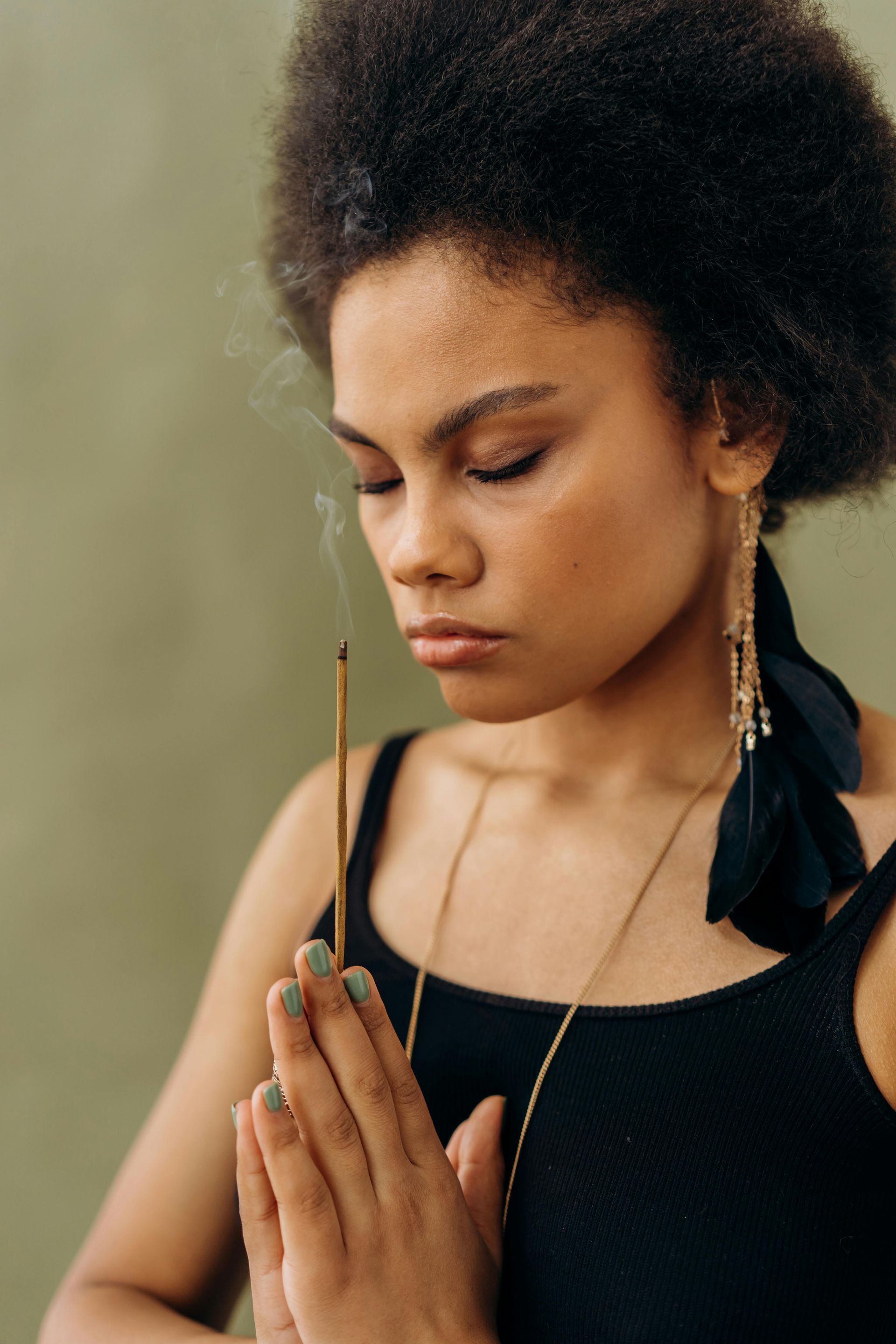 Woman praying with burning incense