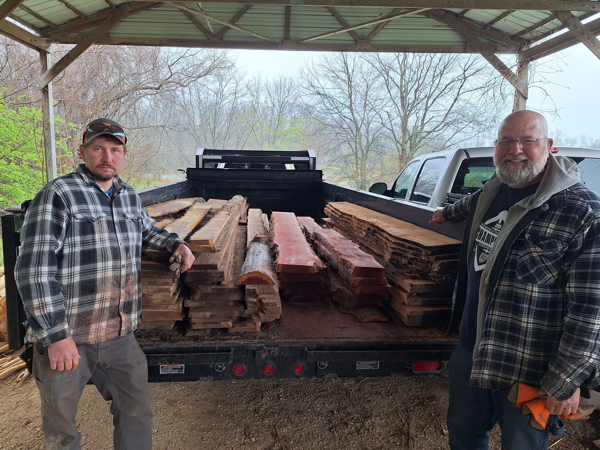 Snellen Wood Products Employees standing next to trailer bed full of milled cedar