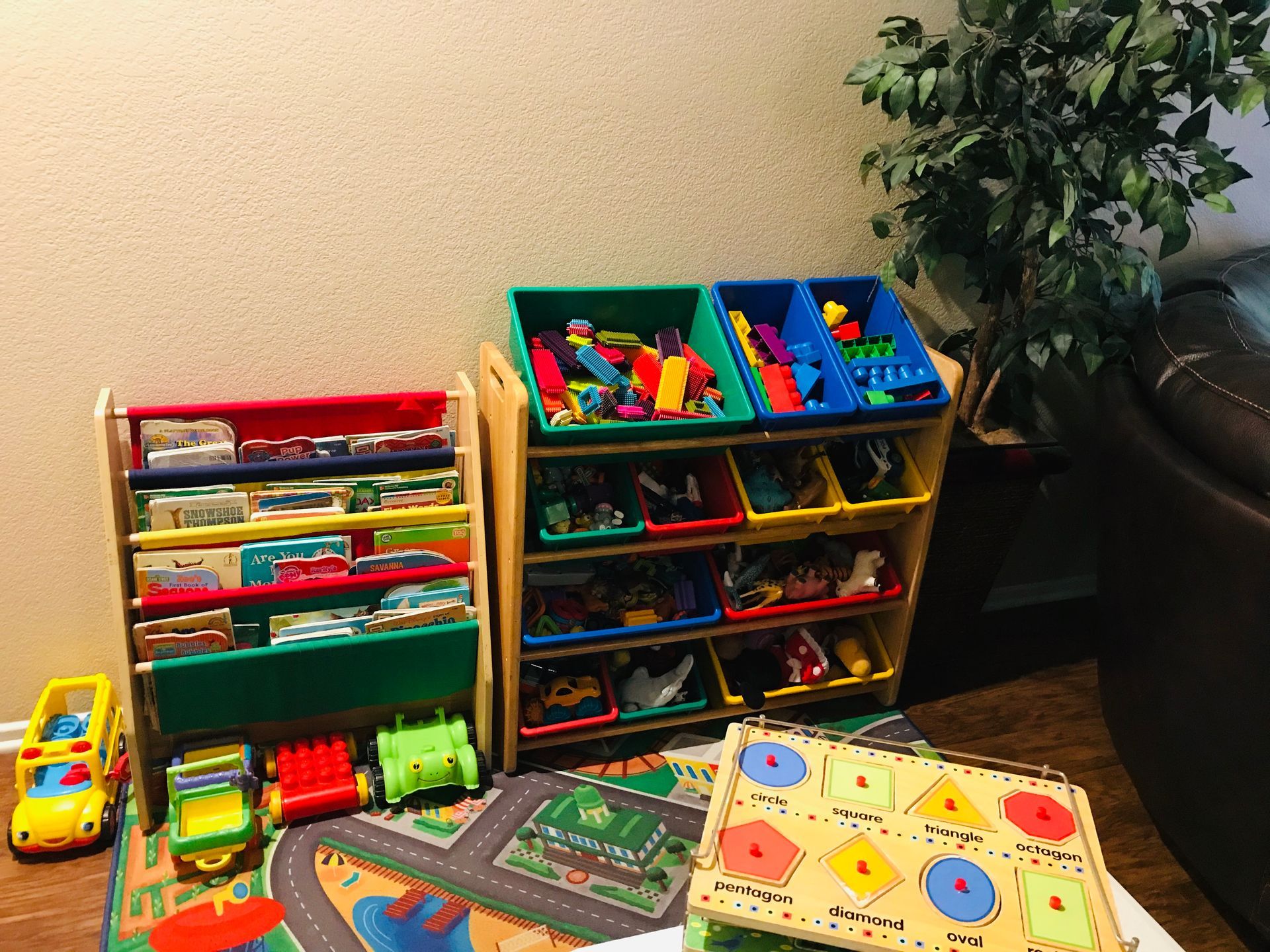 Child wearing a hat, focused on items on a table. Other children in the background.