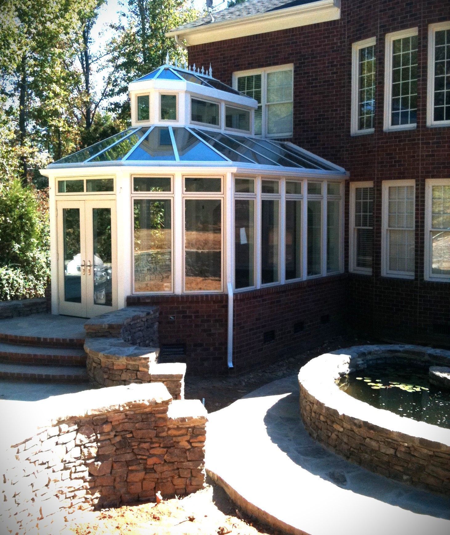 A patio with a table and chairs and umbrellas