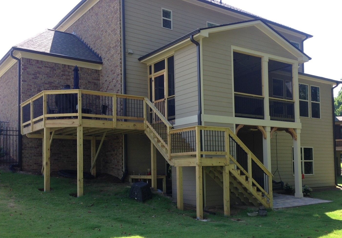 A house with a screened in porch and stairs