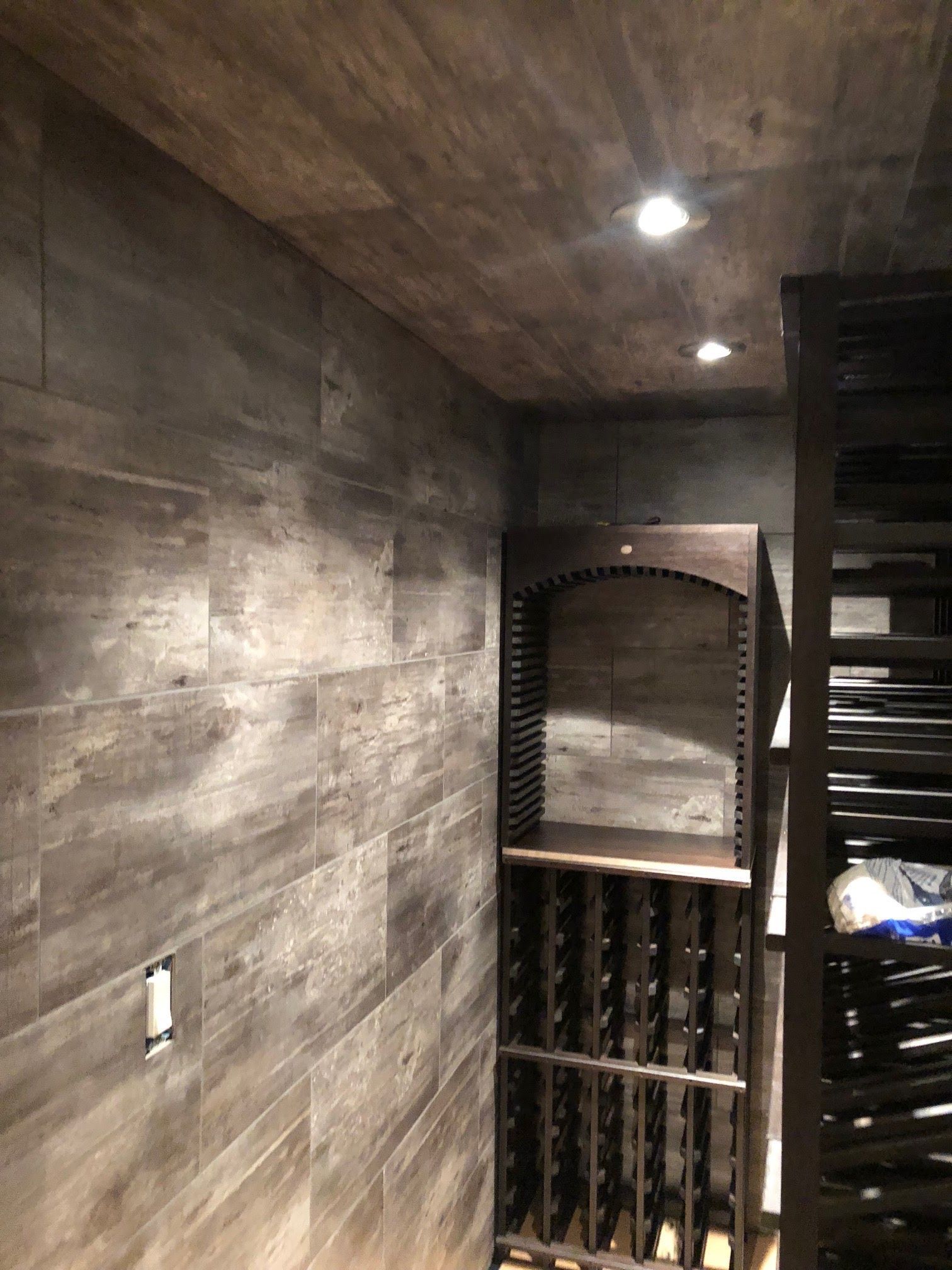 A wine cellar with wooden shelves and a wooden ceiling.