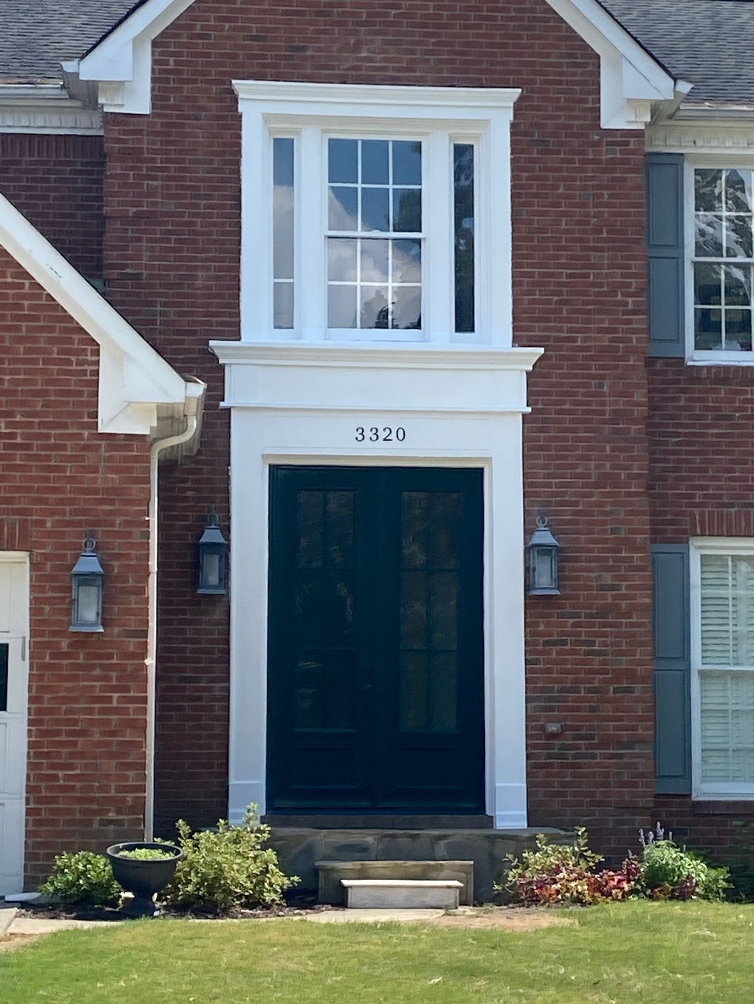 The front of a brick house with a black door