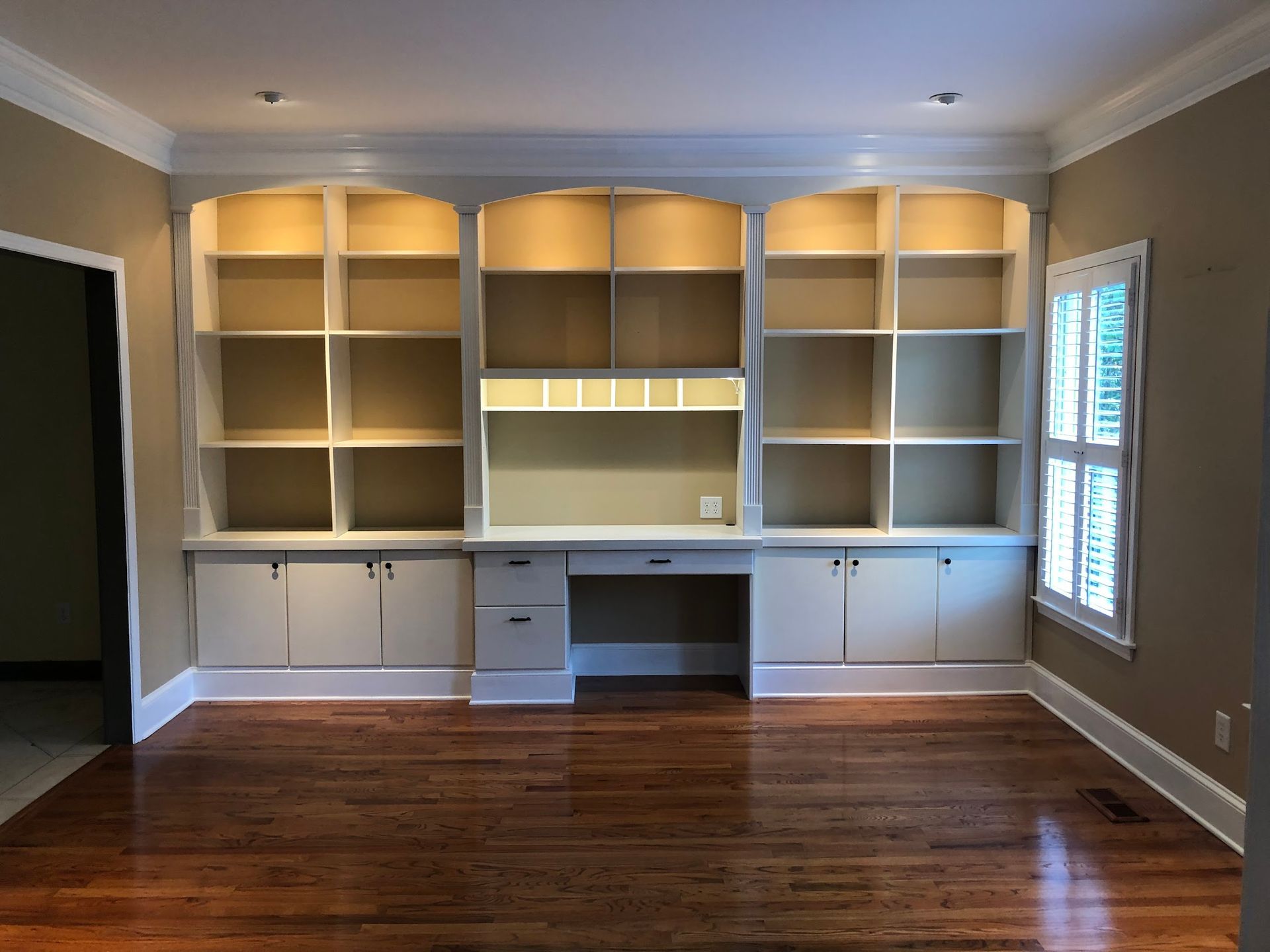 A large empty room with lots of shelves and cabinets