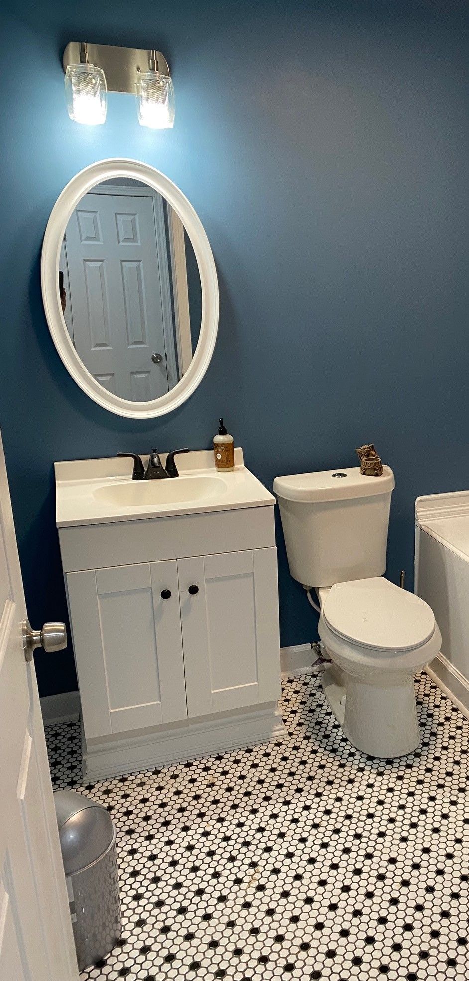 A bathroom with two sinks , a mirror and a window.
