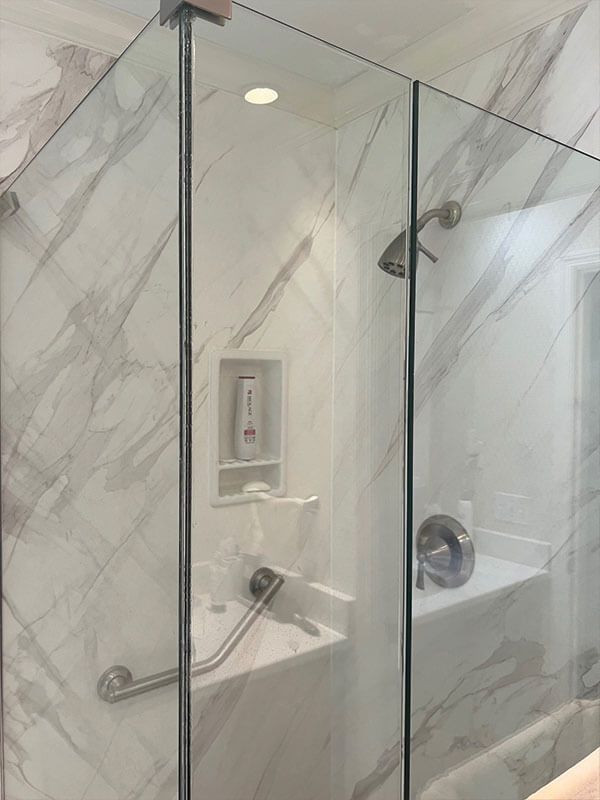 A bathroom with a bathtub and a shower stall with a glass door.