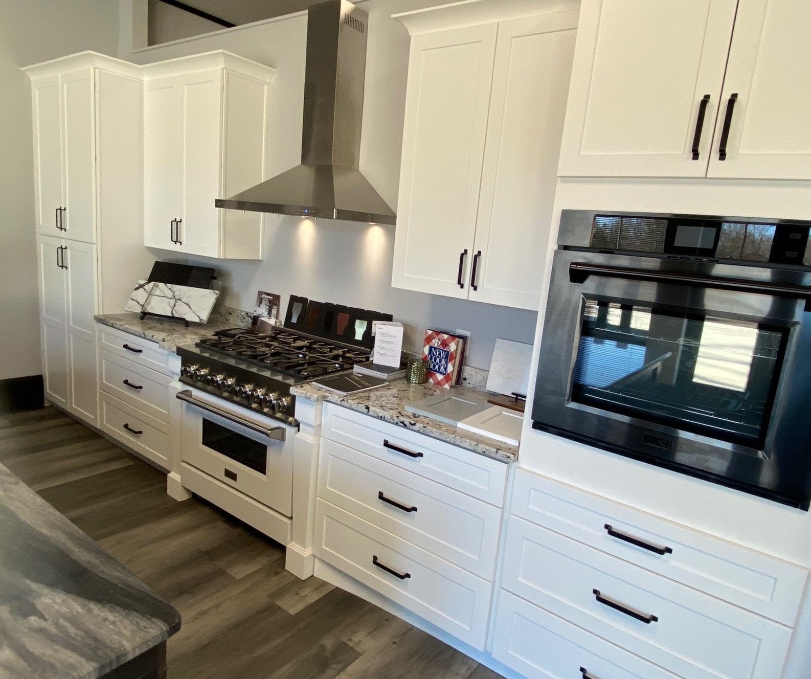 An empty kitchen with hardwood floors and yellow walls