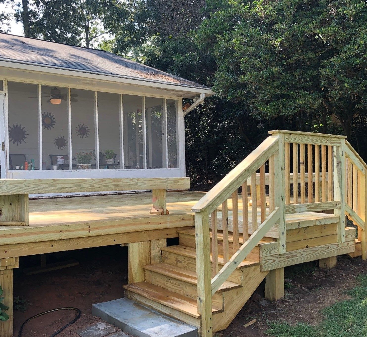A wooden deck with stairs leading up to it