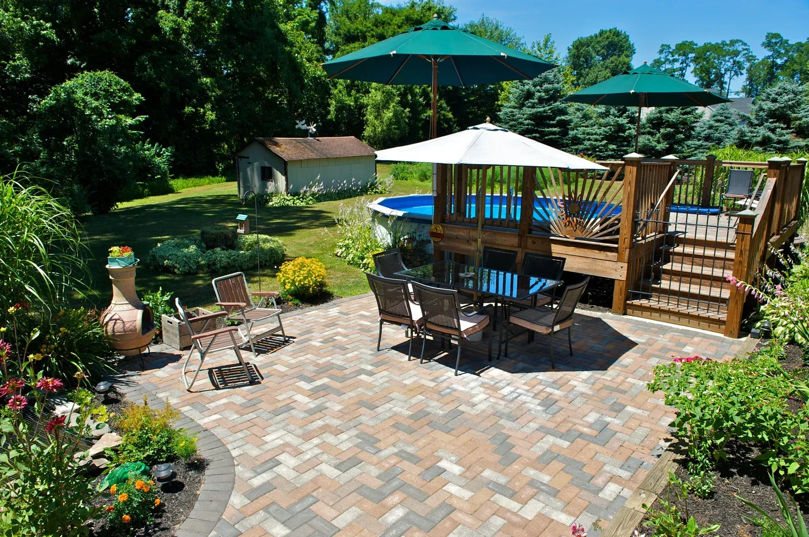A patio with a table and chairs and umbrellas