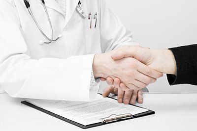 physician shaking hand of patient