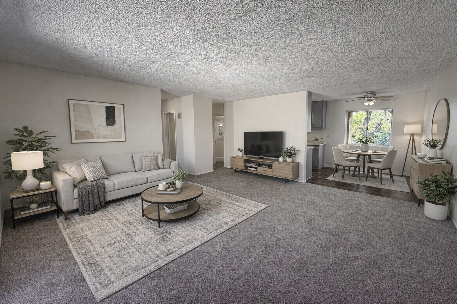 Living room with gray carpet, couch, and dining area.