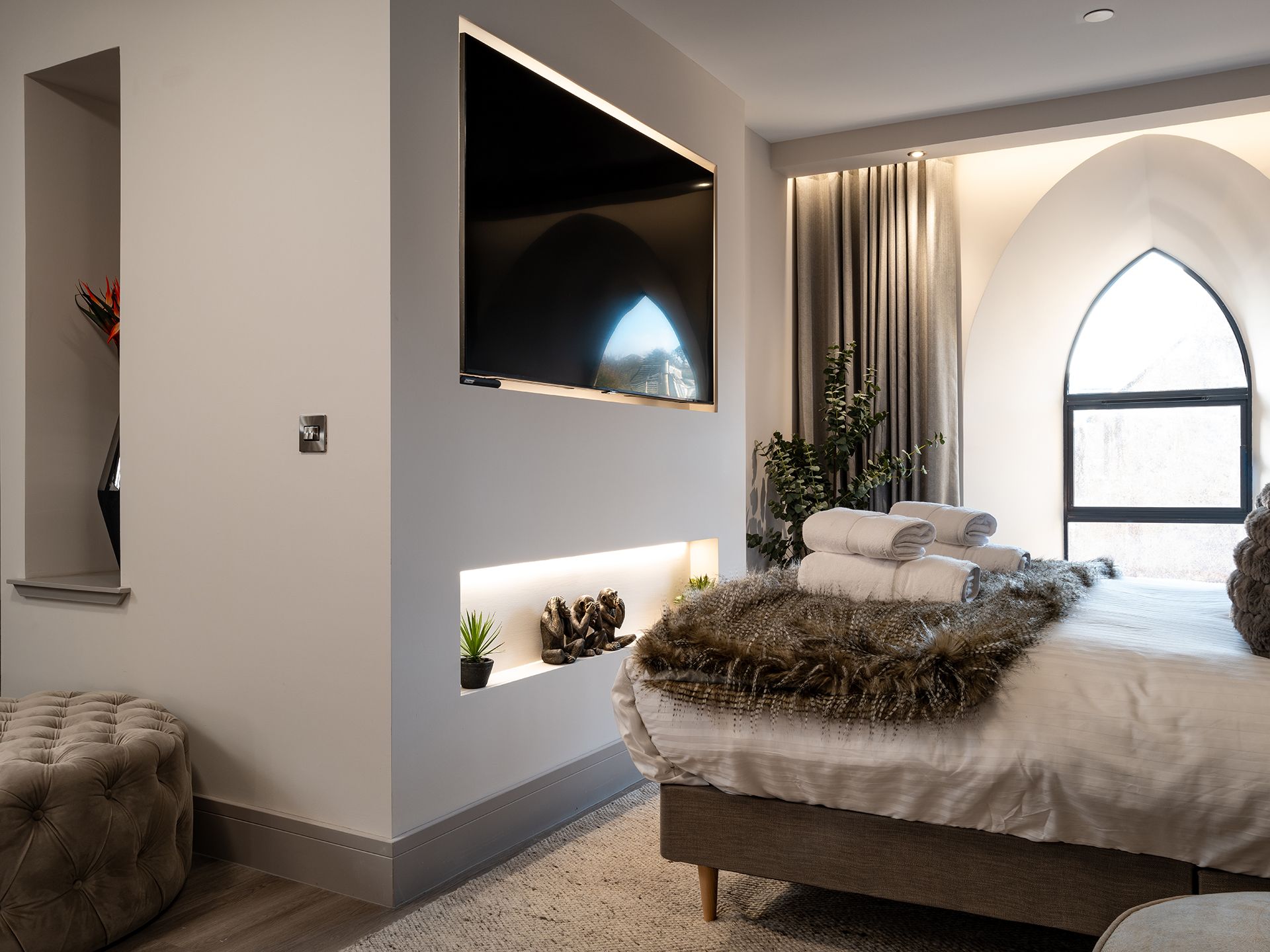 A bedroom with a large bed and a flat screen tv