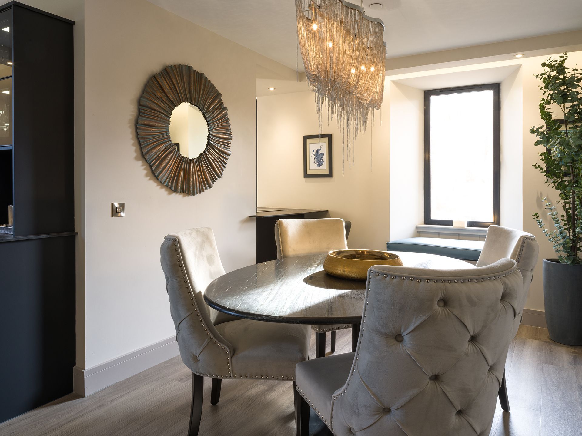 A dining room with a round table and chairs