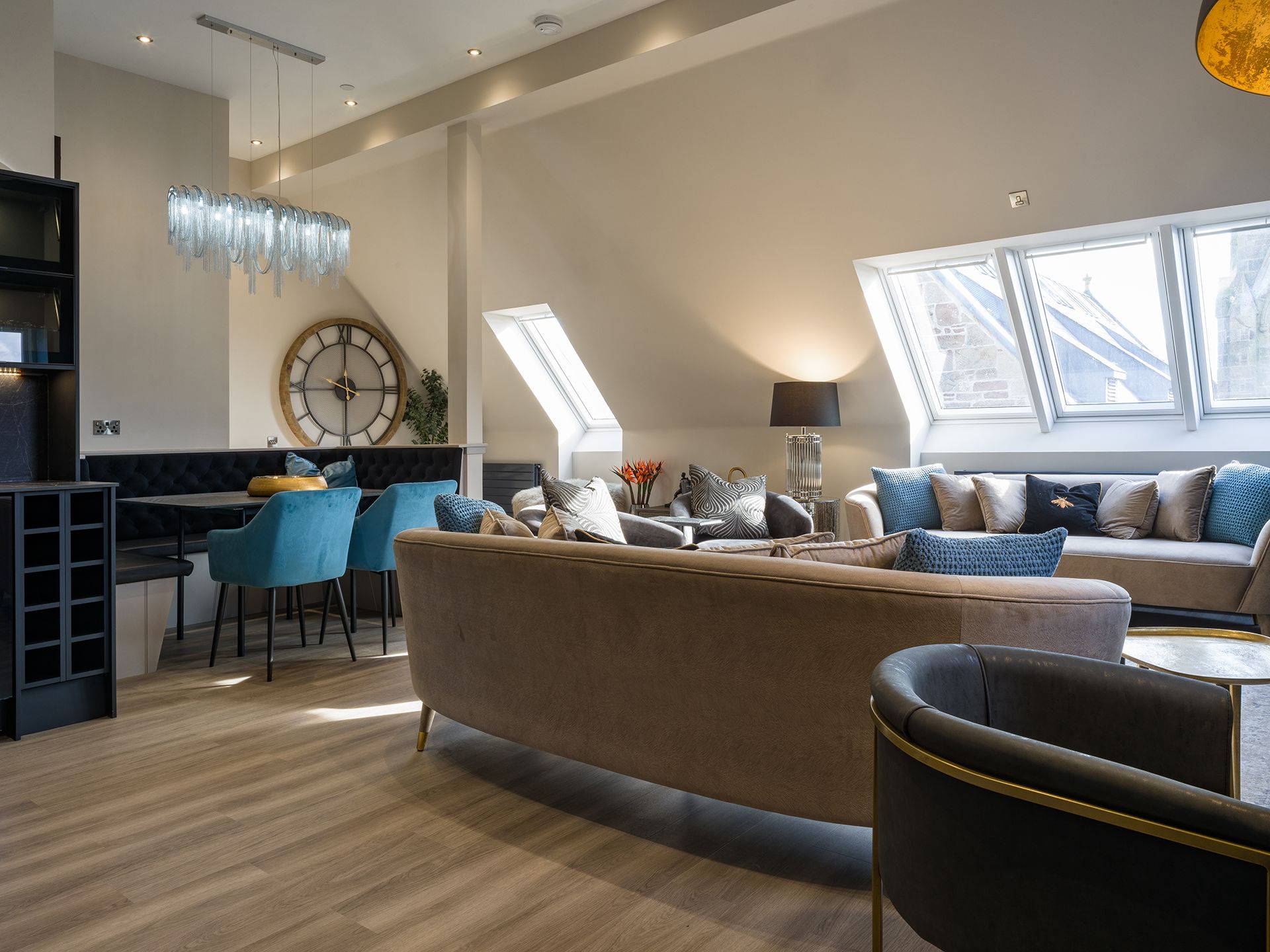 A living room filled with furniture and a clock on the wall