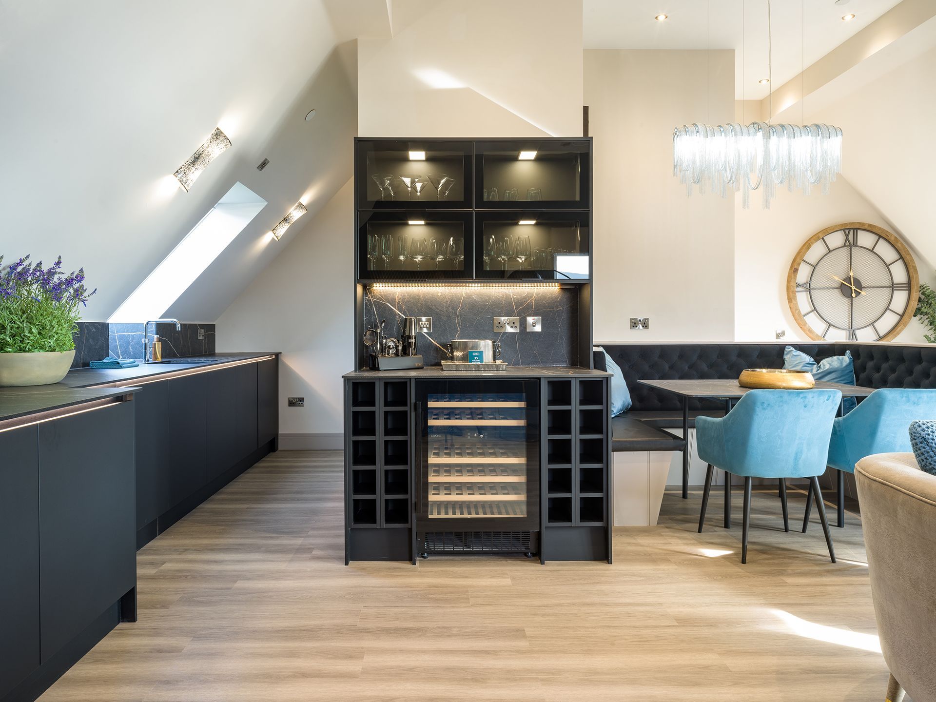 A kitchen and dining room with a clock on the wall