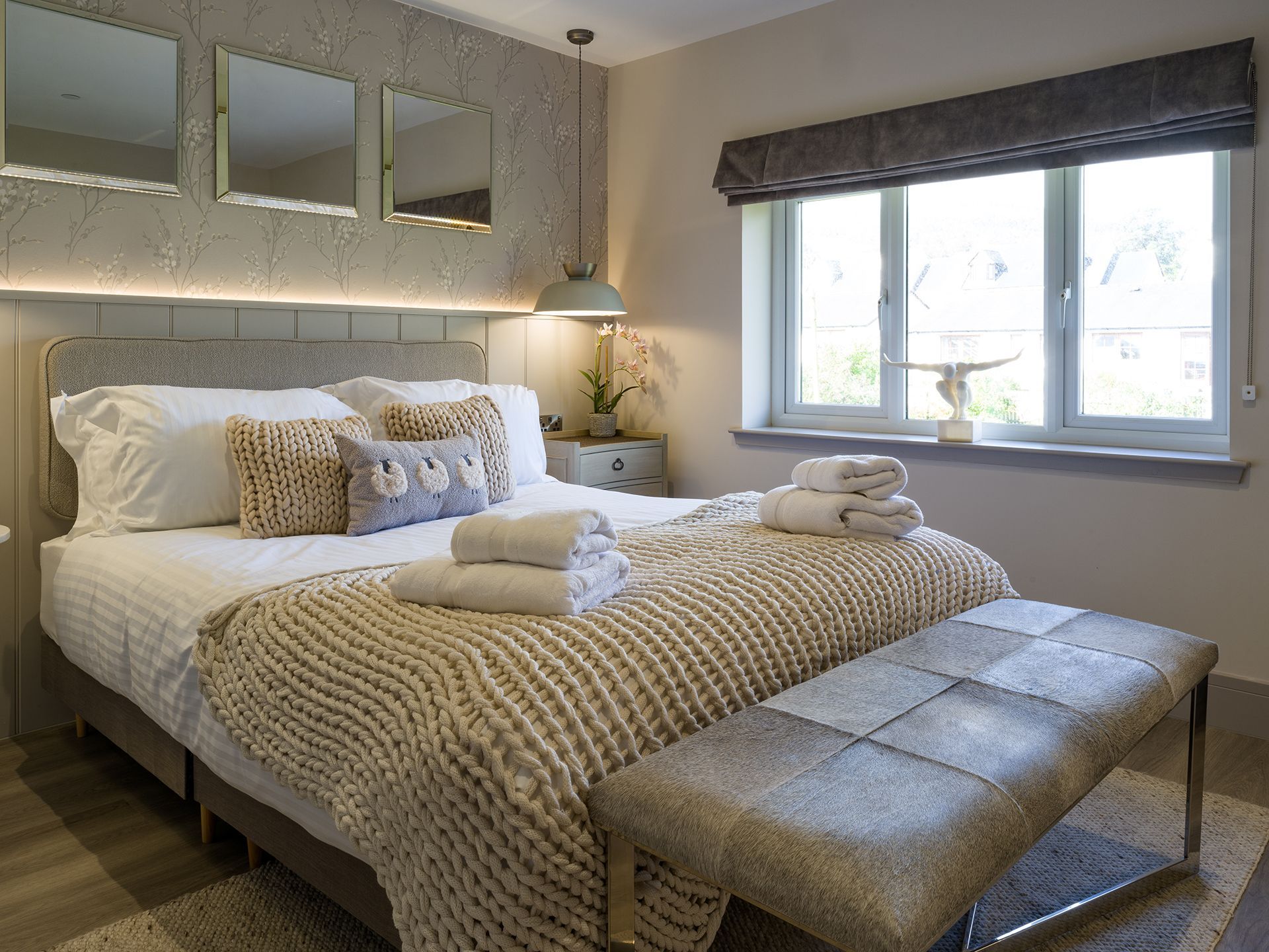 A bedroom with a large bed and a window.