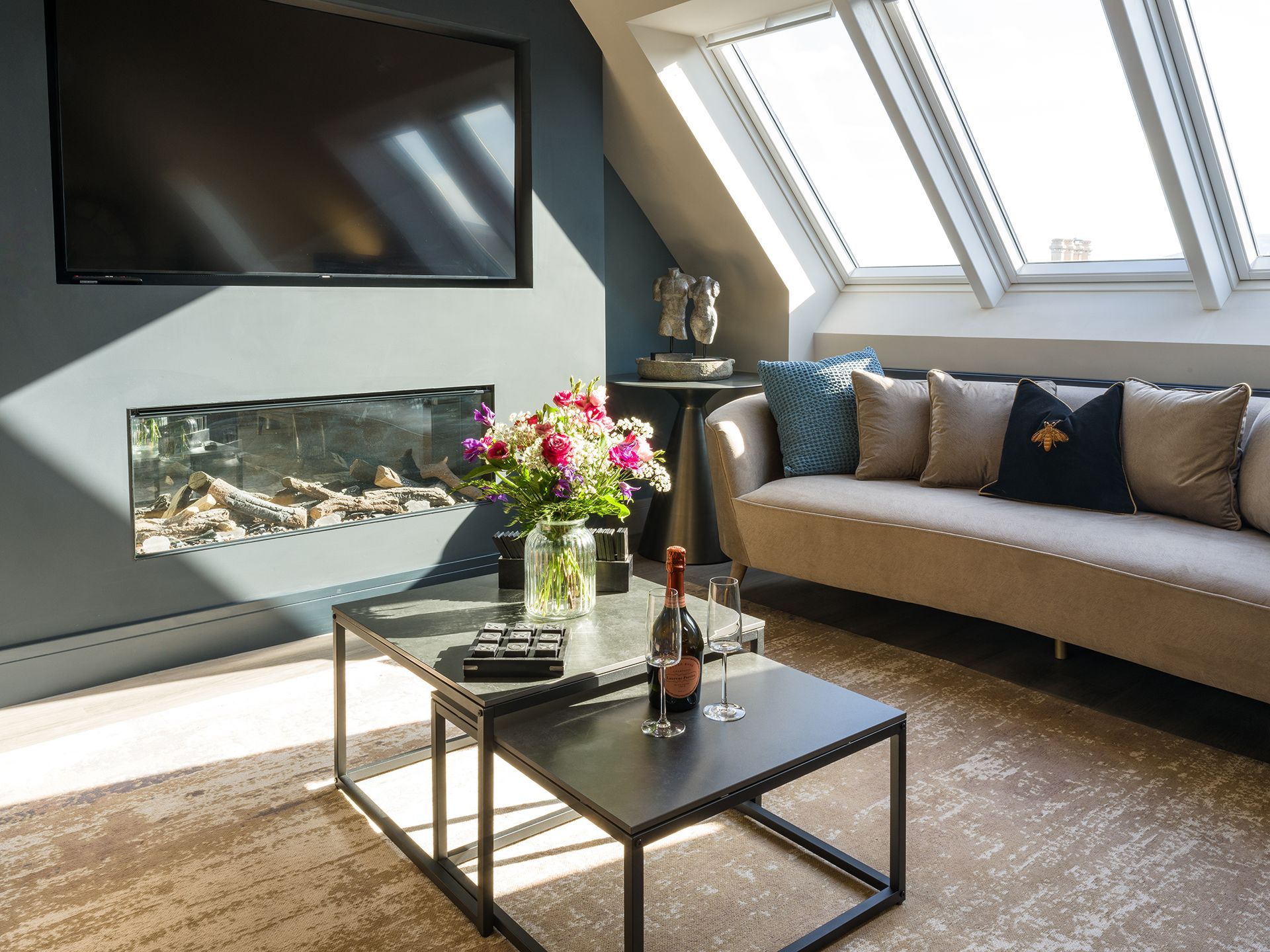 A living room with a couch a coffee table and a flat screen tv