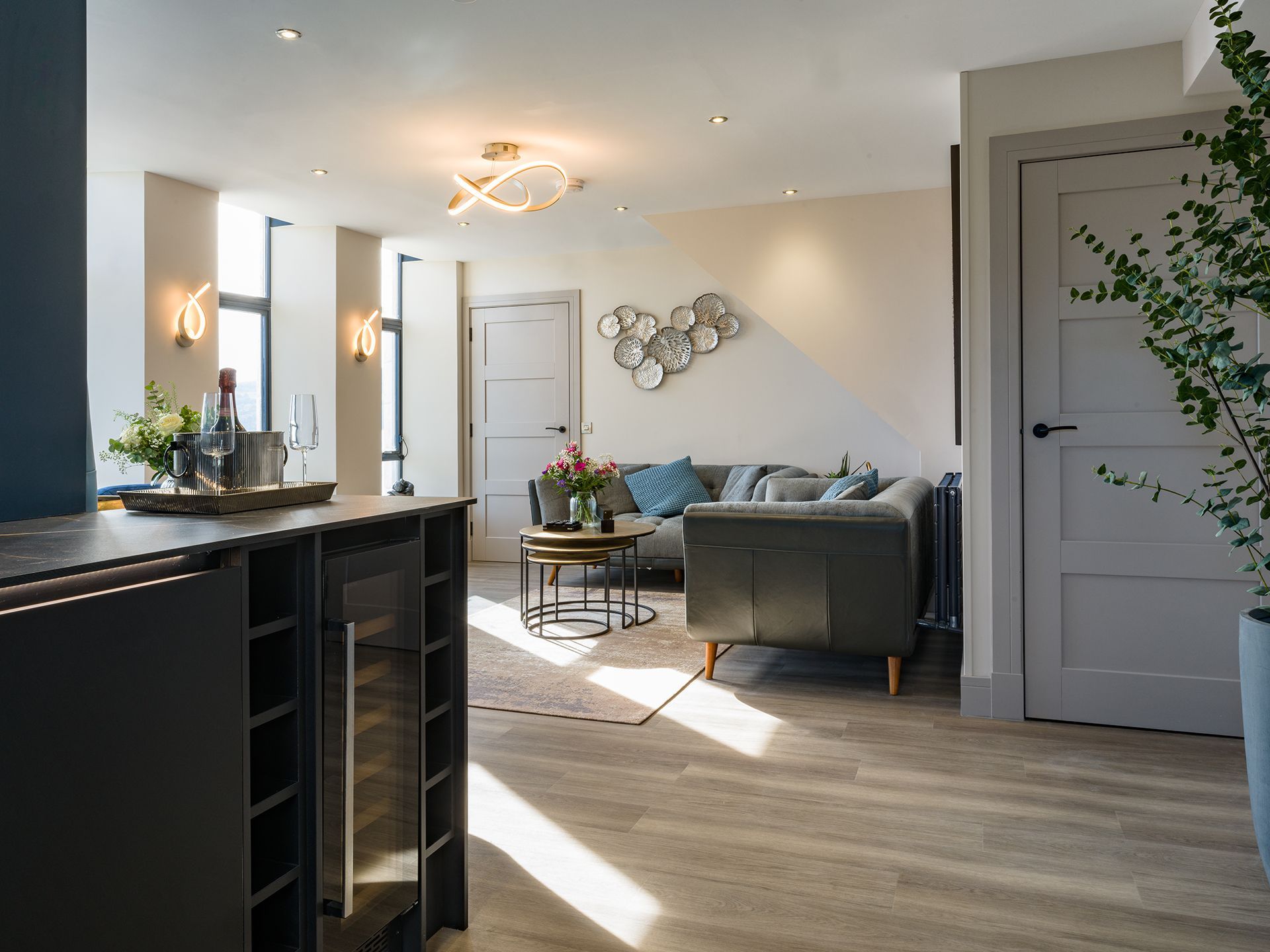 A living room with a couch , table , and refrigerator.