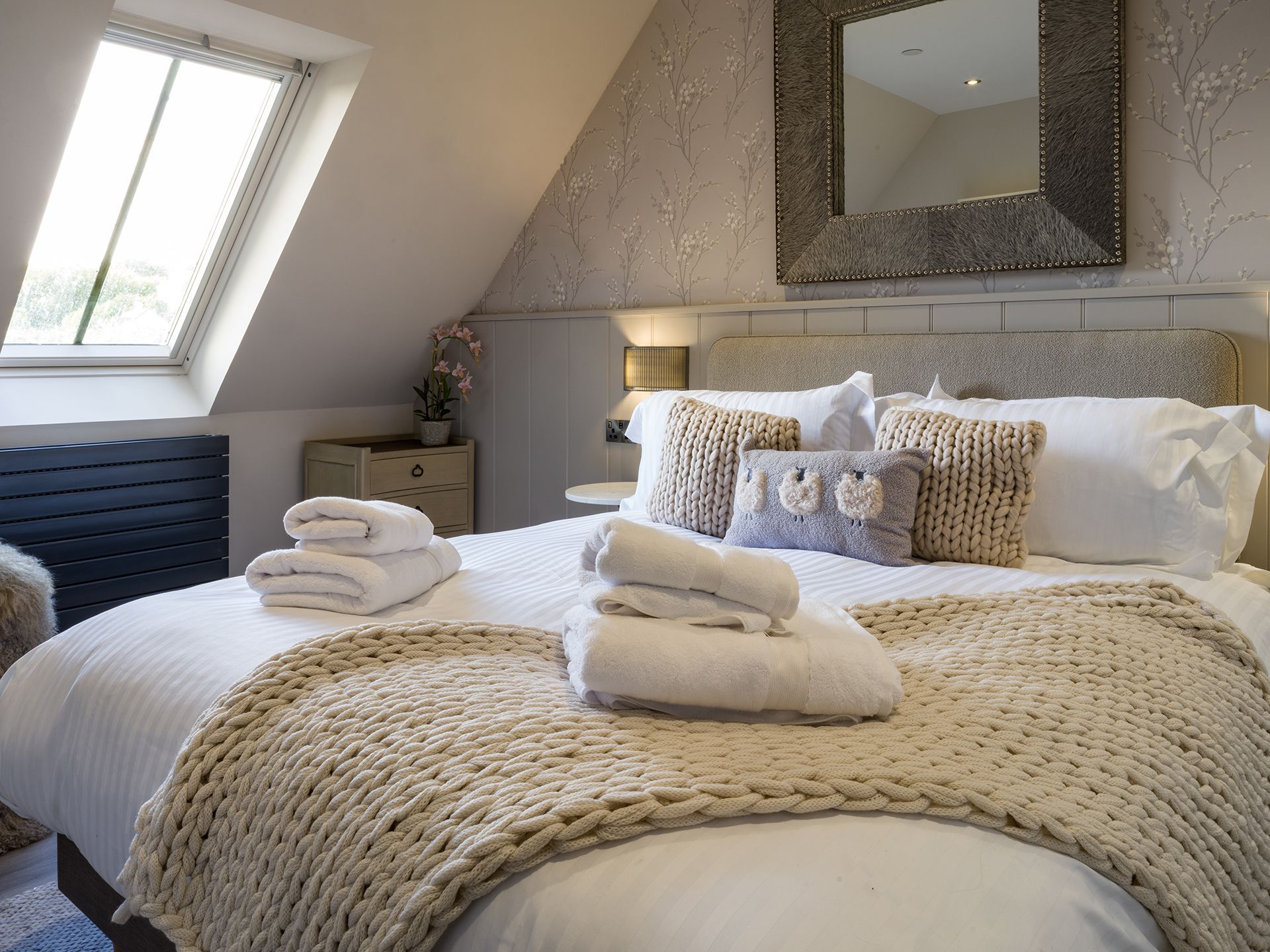 A bedroom with a large bed and a window