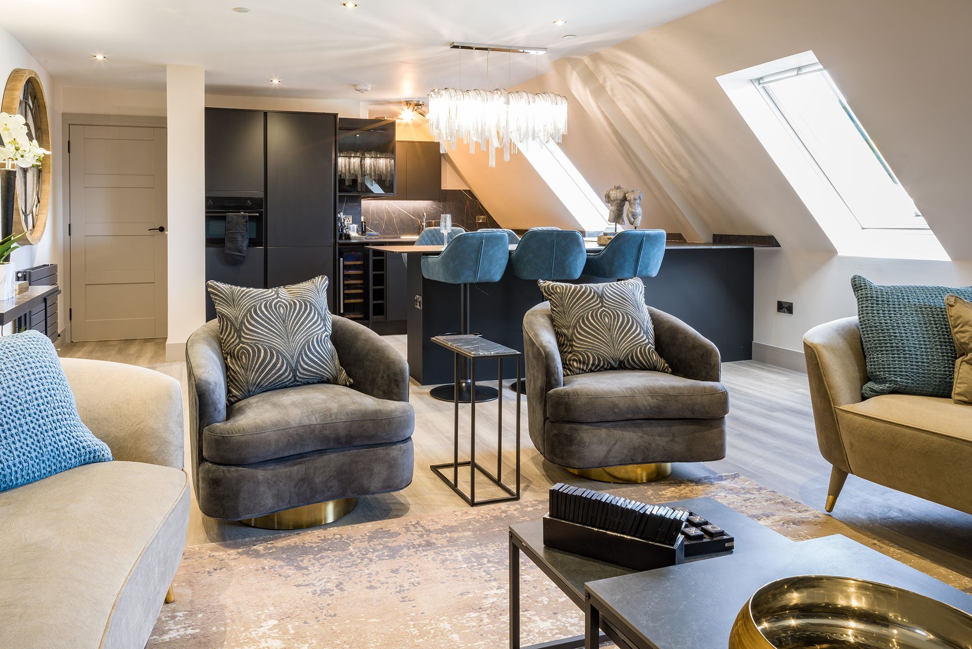 A living room with a couch , chairs , and a coffee table.