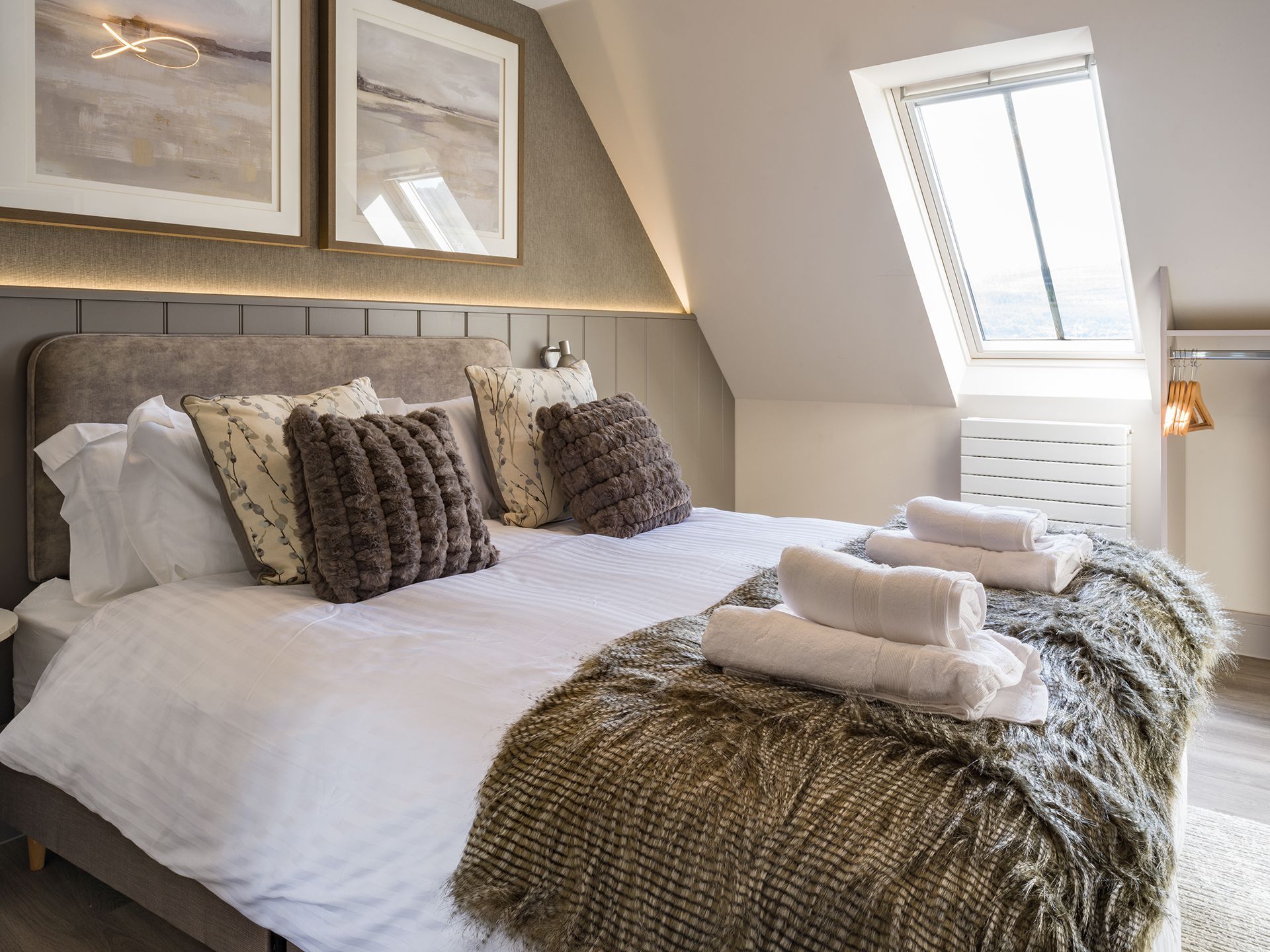 A bedroom with a large bed and a window.