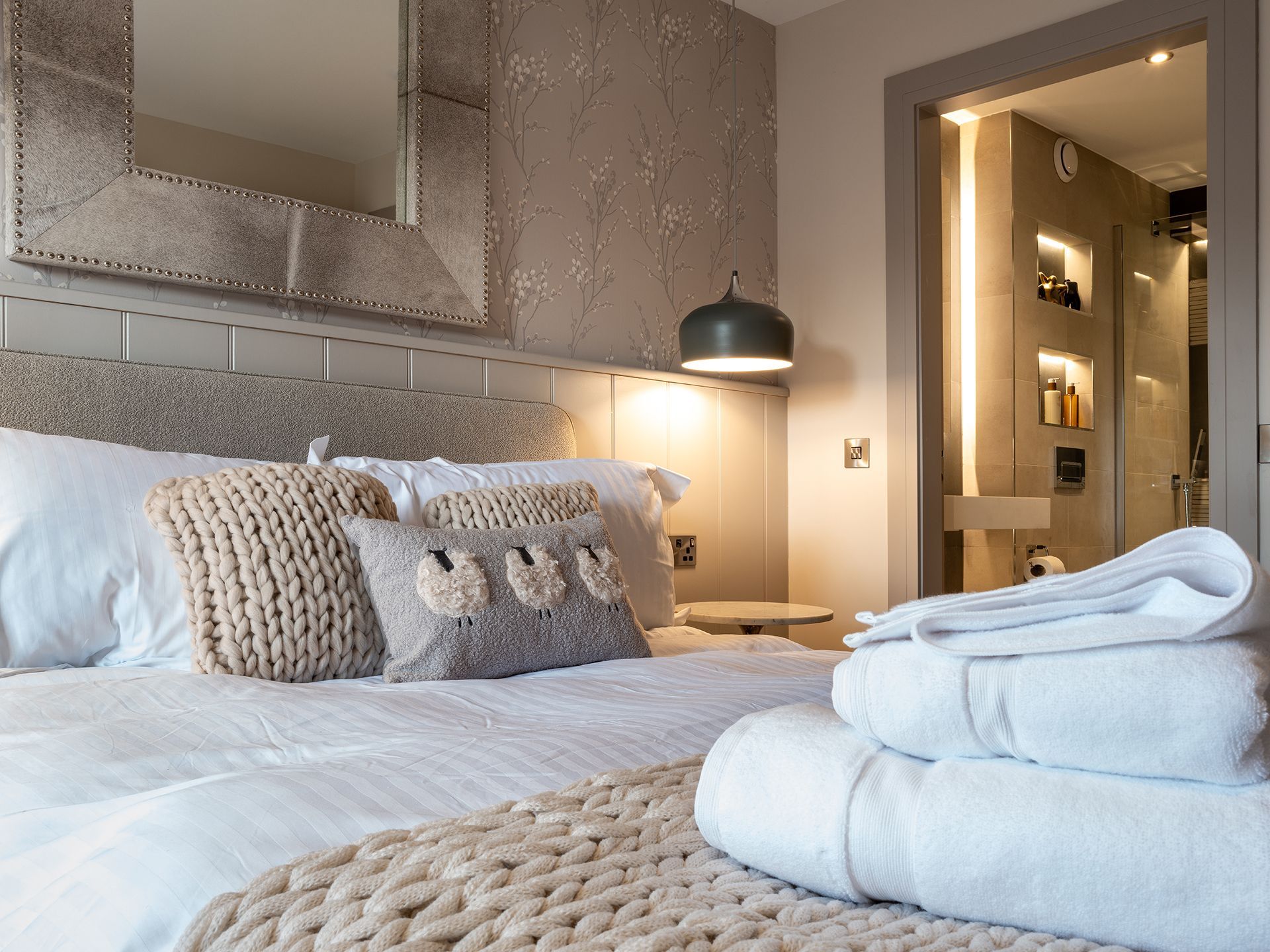 A bedroom with a king size bed and a mirror