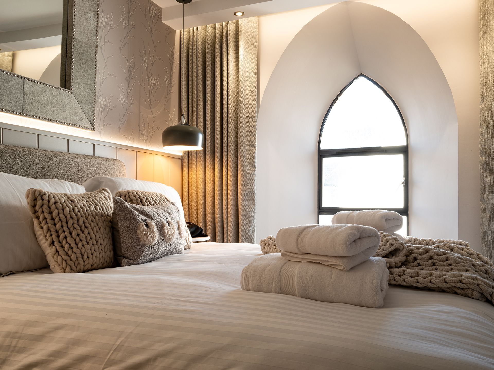 A hotel room with a bed and a window