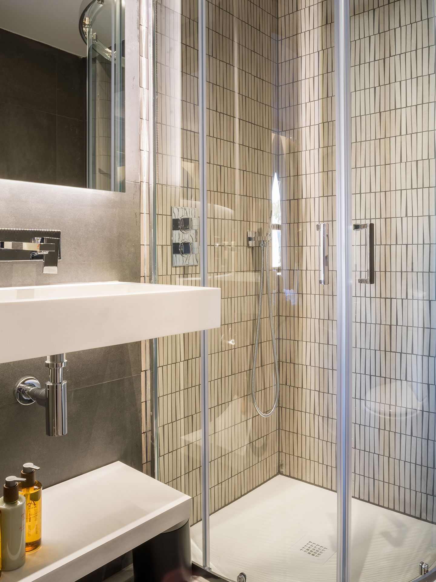 A bathroom with a sink and a walk in shower