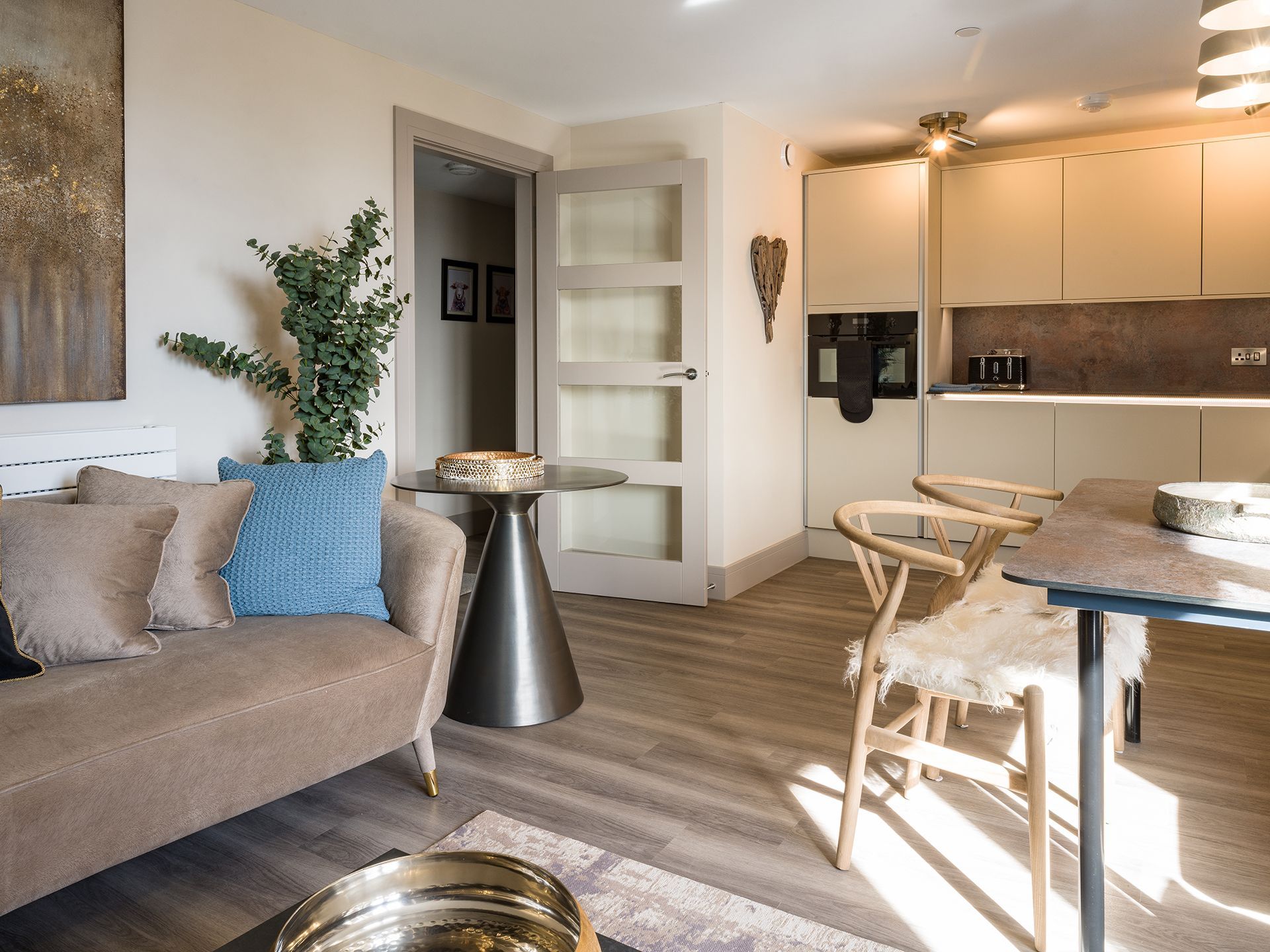 A living room with a couch , table and chairs.