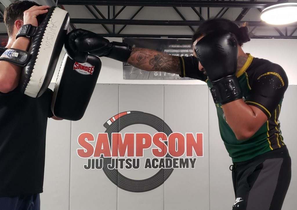two men are practicing martial arts at sampson jiu jitsu academy