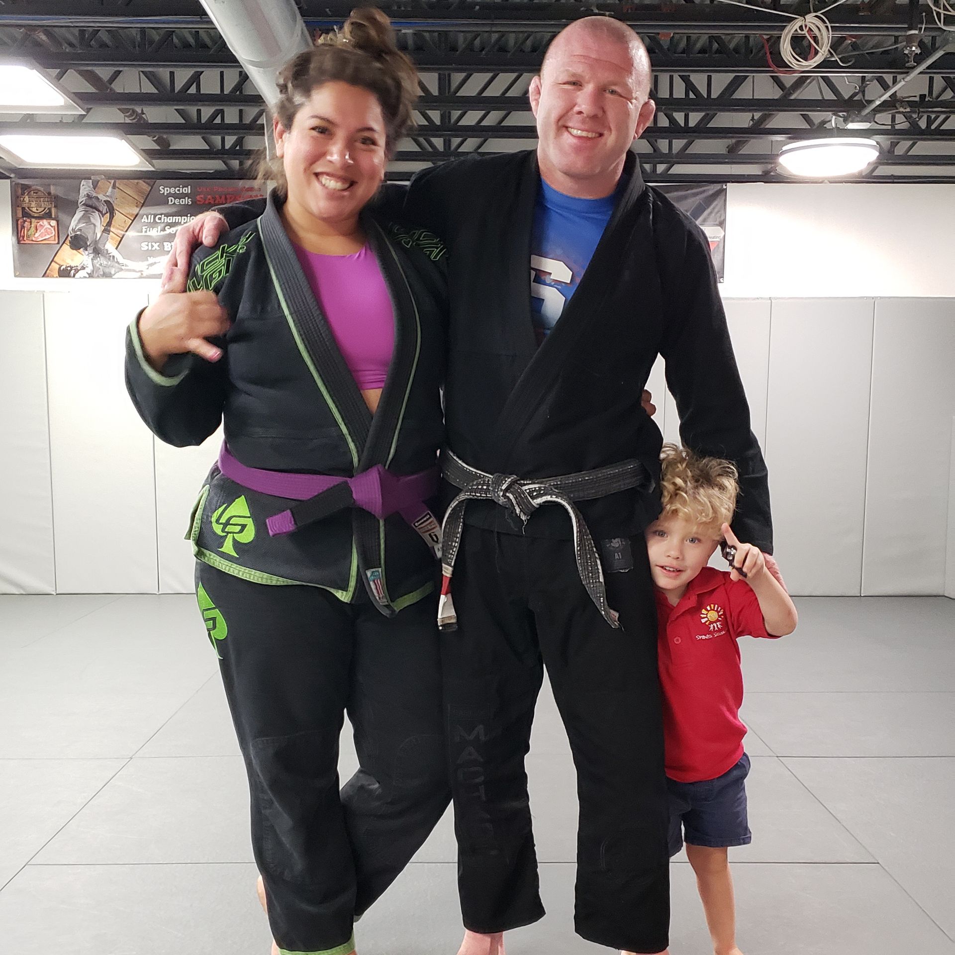 A man and a woman are posing for a picture with a child