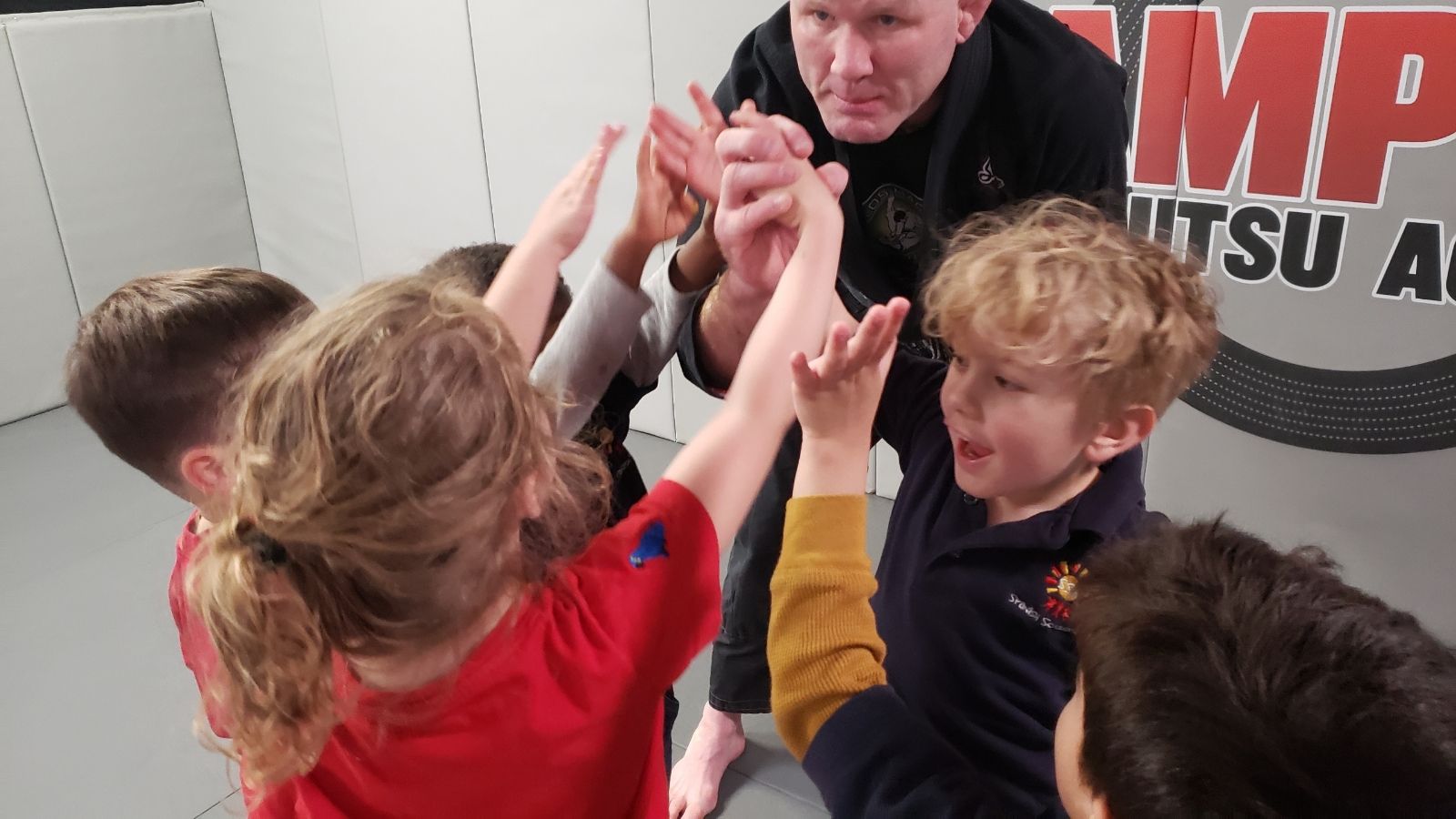 A group of children are giving each other a high five.