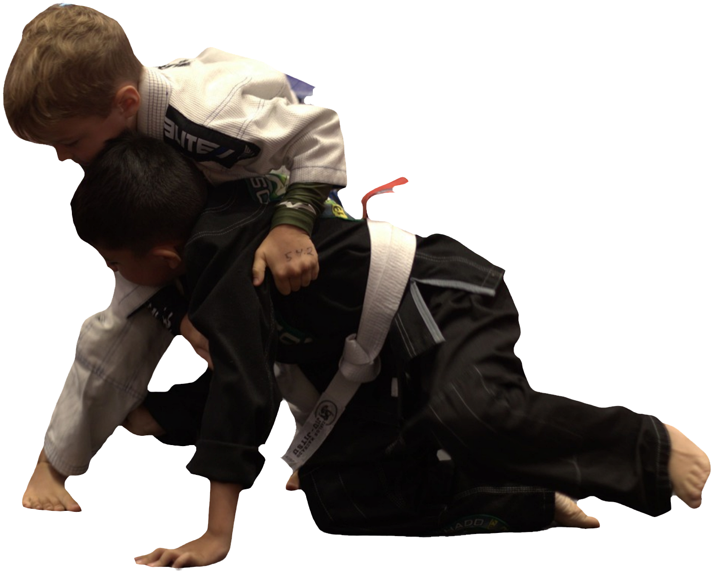 Two young boys are practicing martial arts and one of them has the letter a on his belt