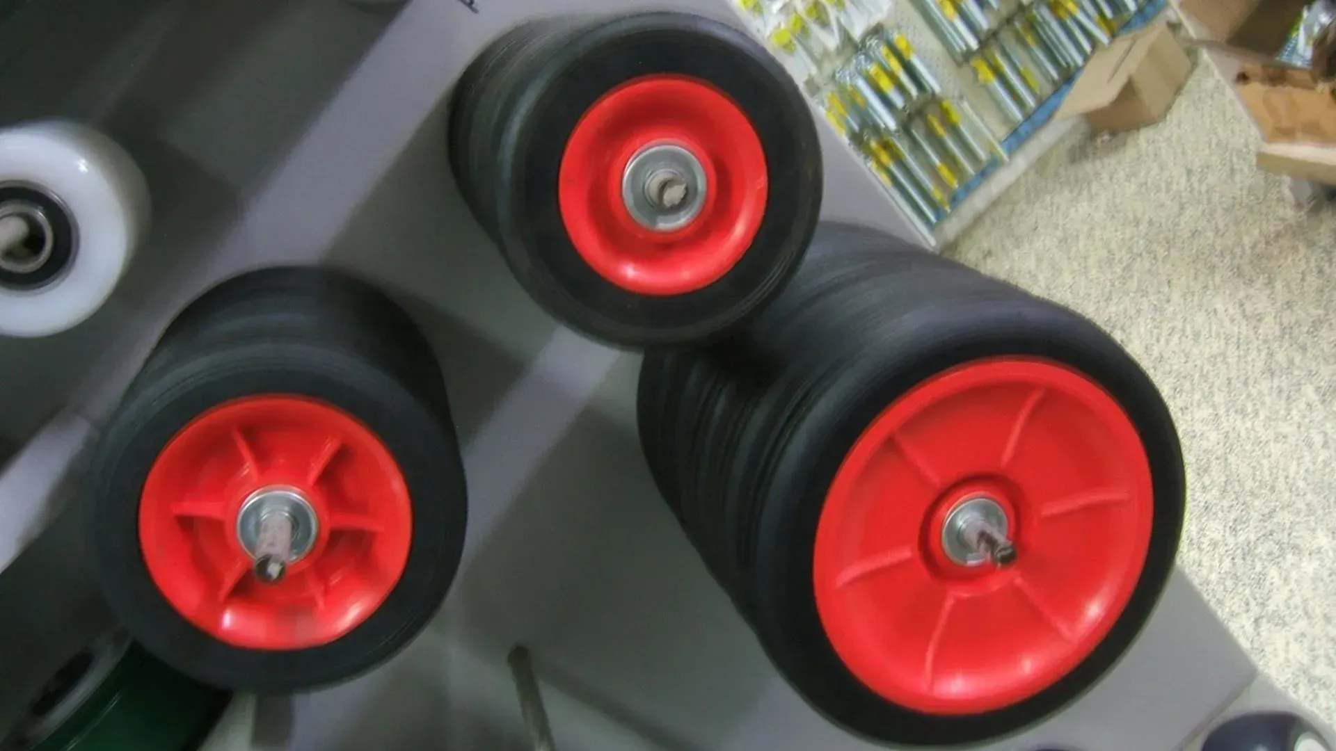 Three Wheels With Red Rims Are Stacked on Top of Each Other — Coffs Harbour Bearing Centre in Coffs Harbour, NSW