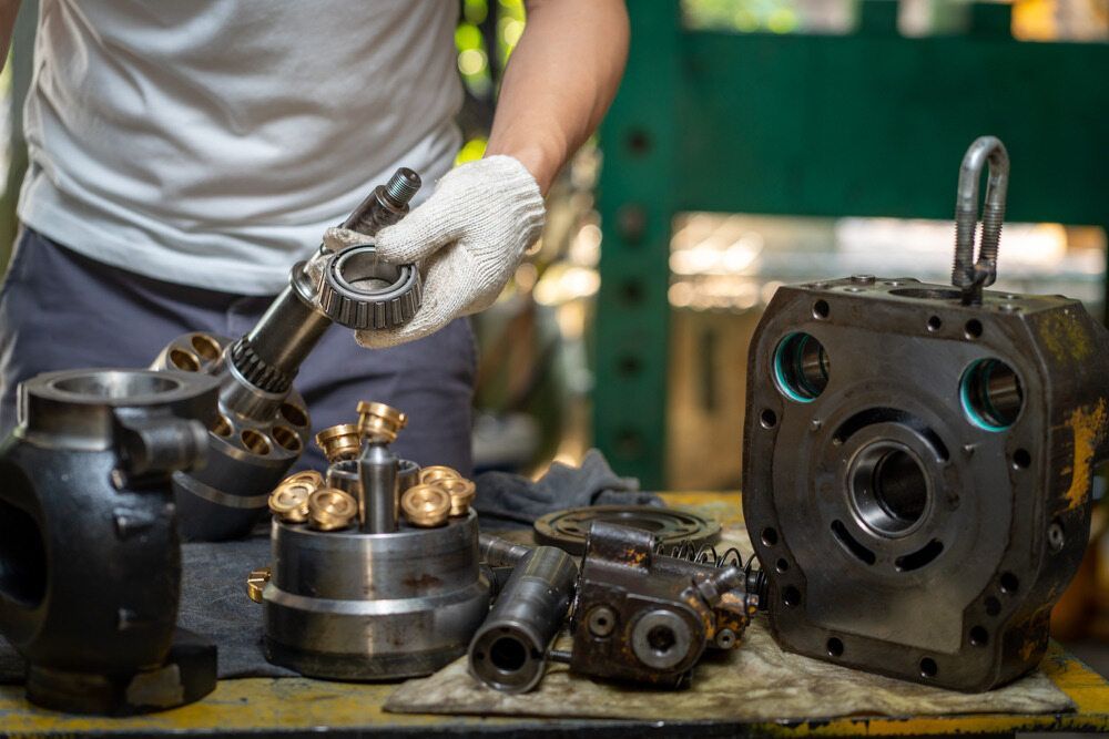 A Man is Working on a Machine in a Factory — Coffs Harbour Bearing Centre in Coffs Harbour, NSW