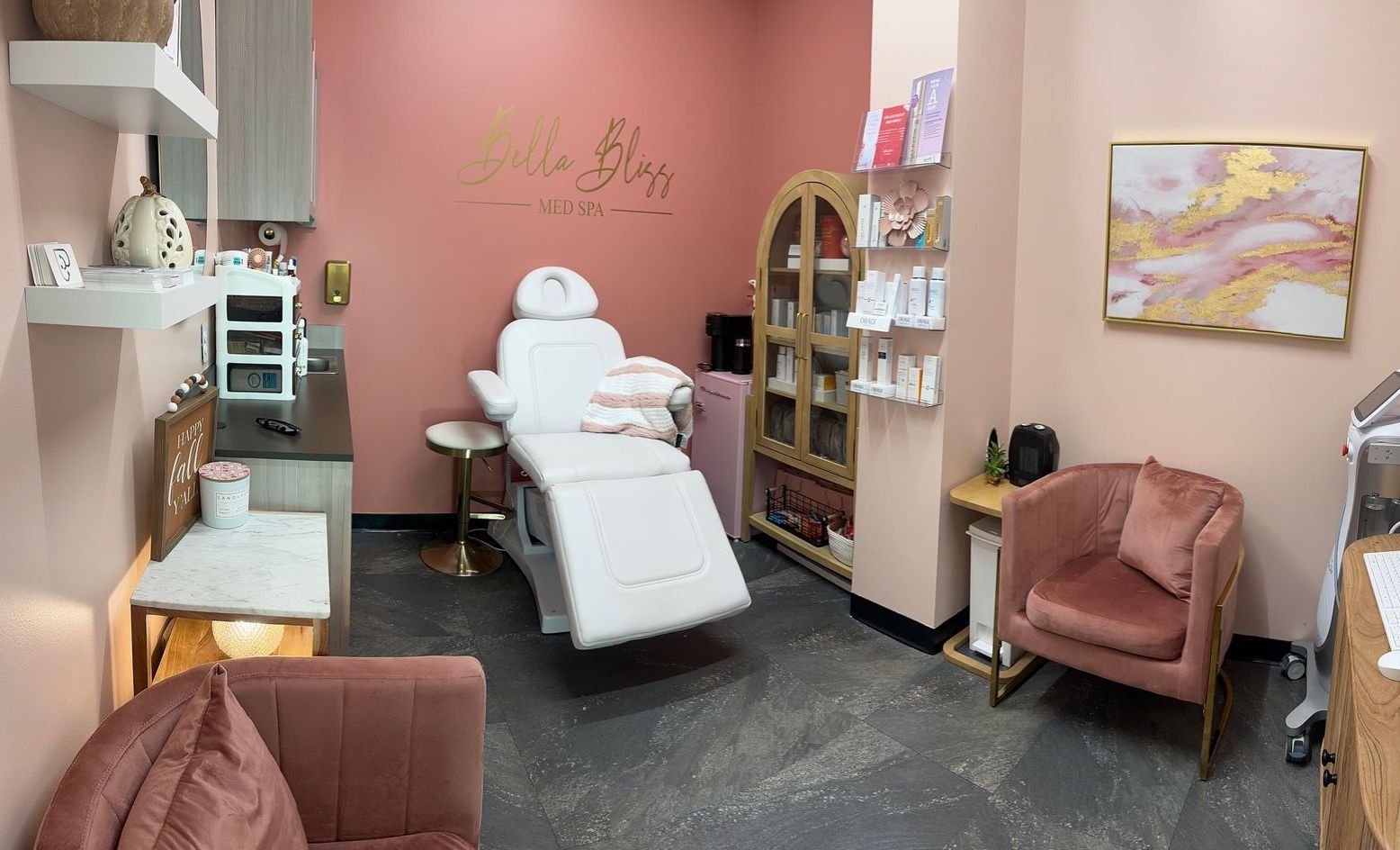 Two women are sitting on a chair in a room.