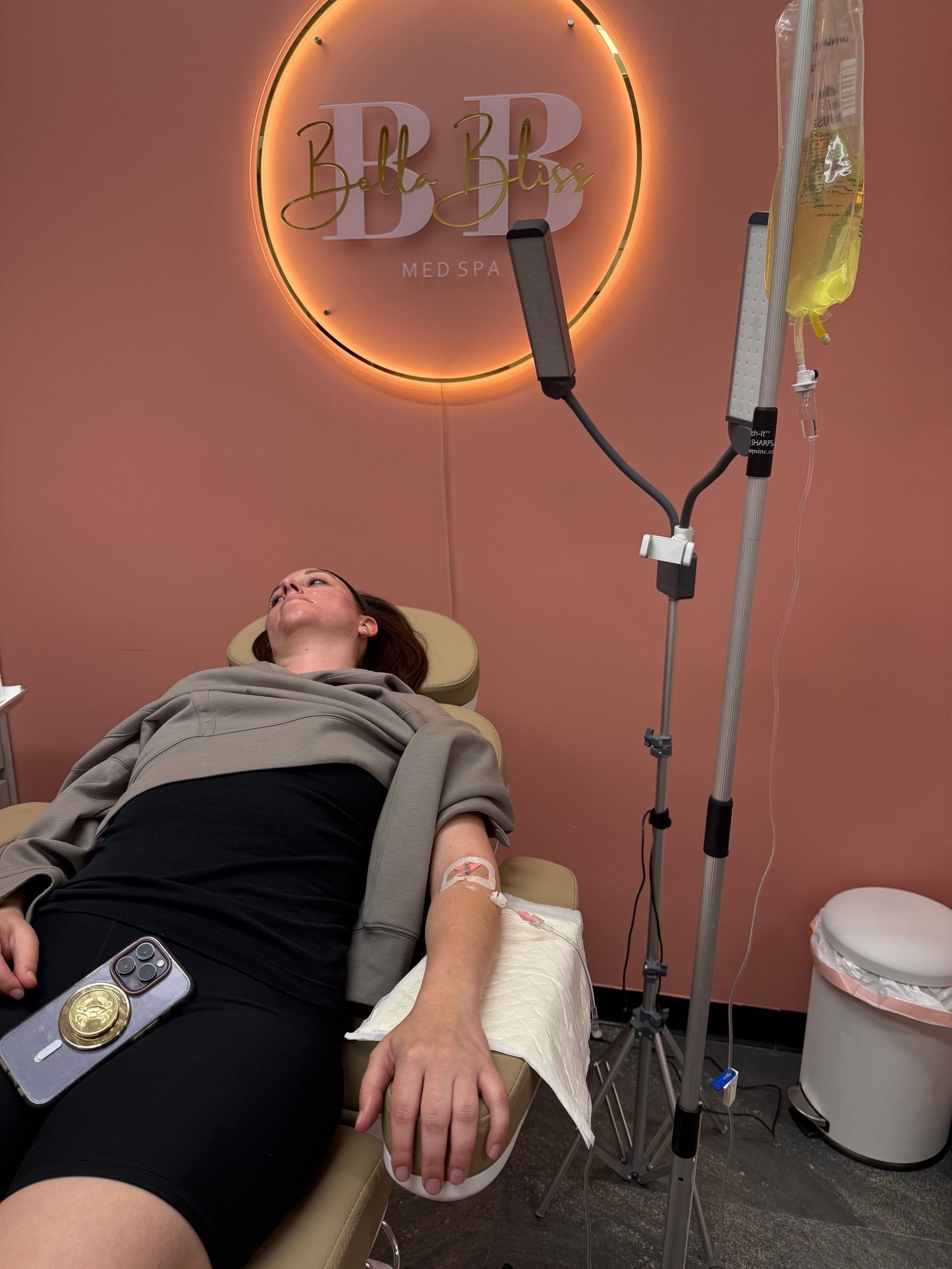 A woman is laying in a chair with an iv in her arm