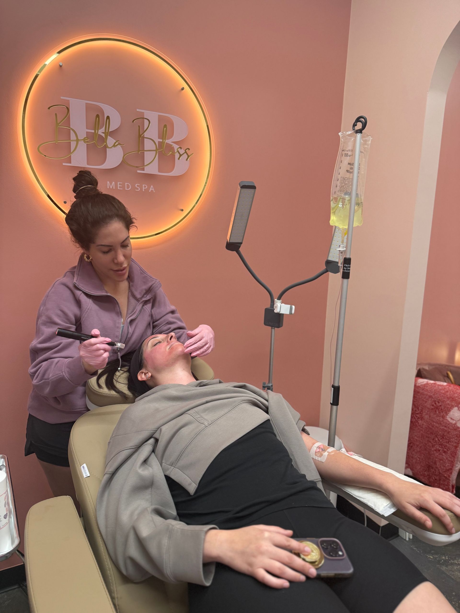 A woman is laying in a chair getting an injection in her arm.