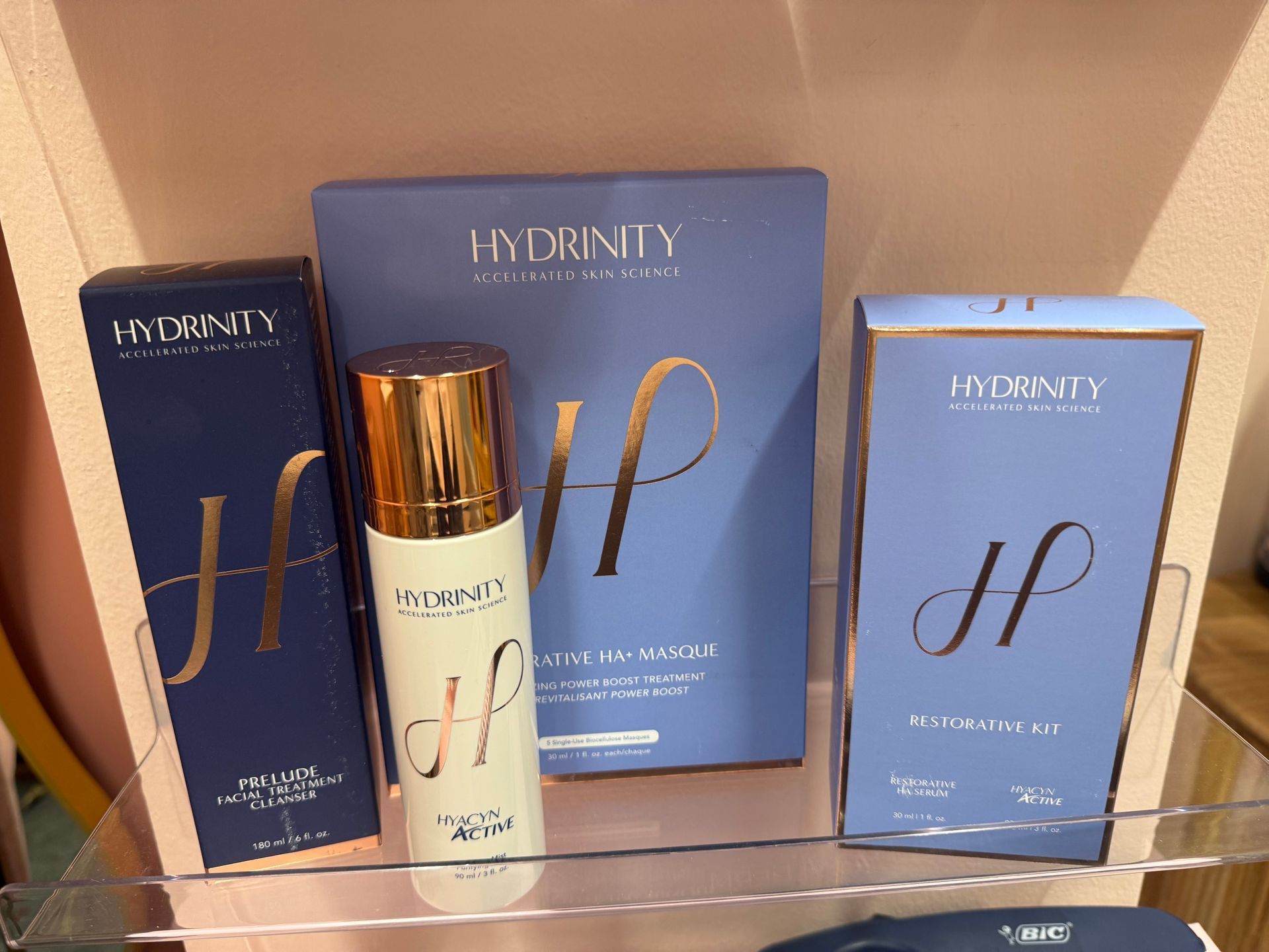 A shelf filled with bottles and boxes of hydrating products.